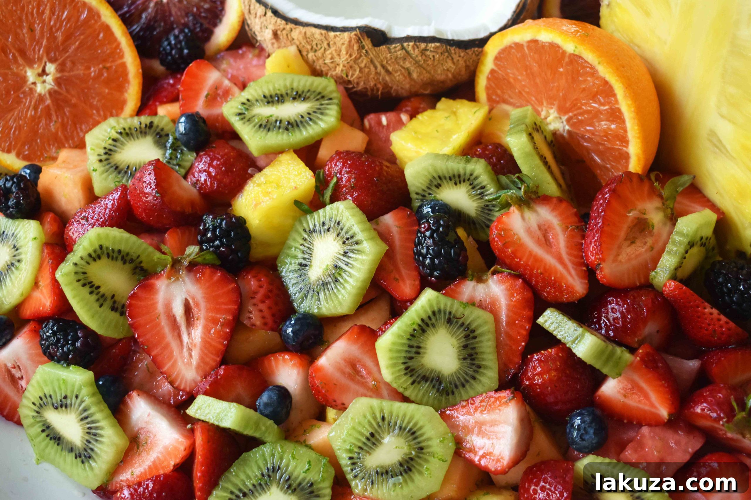 Summer Fruit Salad with Honey Lime Dressing. A healthy side dish! Vibrant fresh fruit with a citrus orange lime honey dressing. www.modernhoney.com