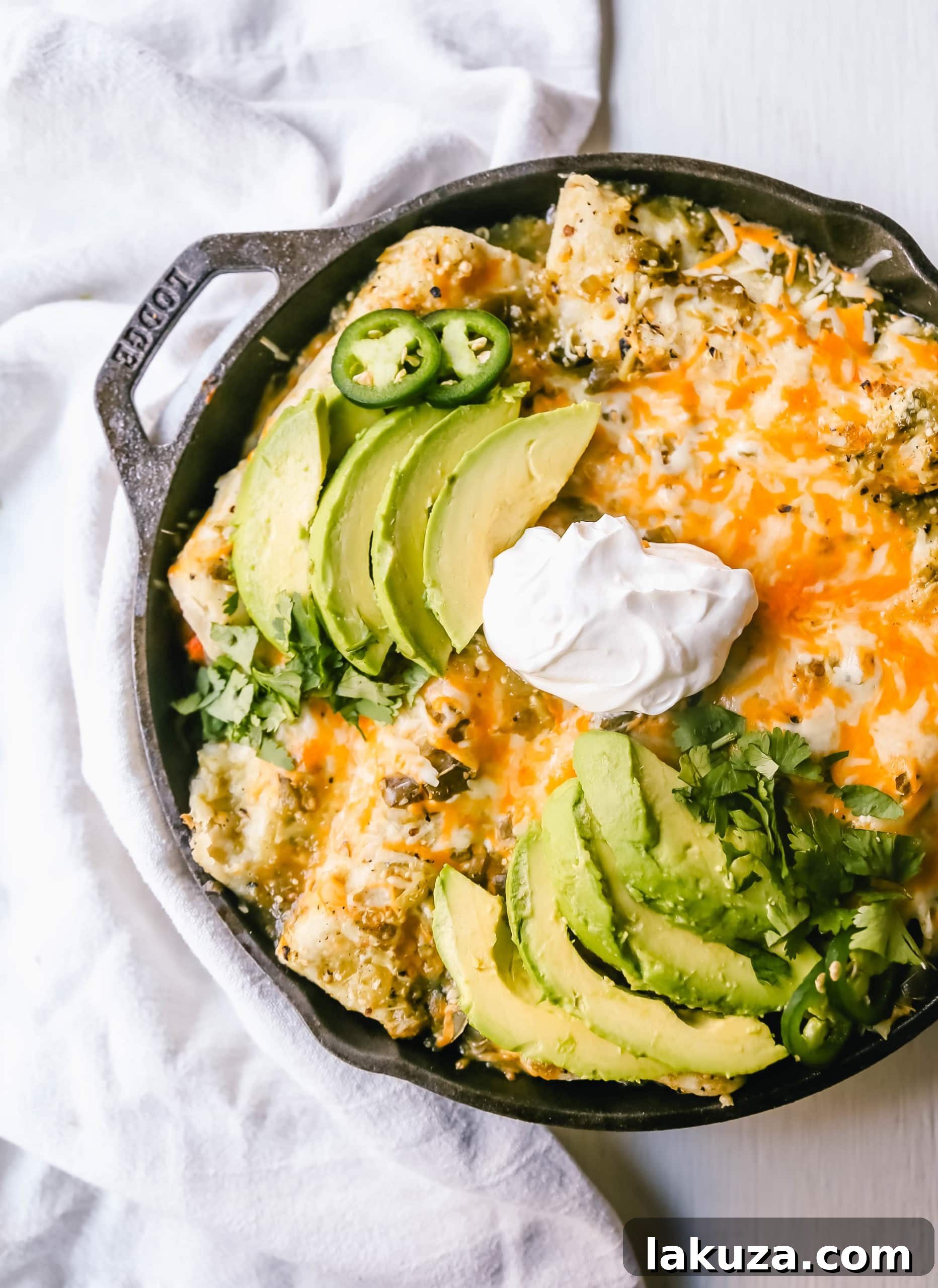 Zesty Sweet Potato and Black Bean Enchiladas 4 A colorful array of fresh ingredients: sweet potatoes, black beans, poblano peppers, and red onion, laid out on a wooden surface, ready for preparing delicious vegetarian enchiladas.