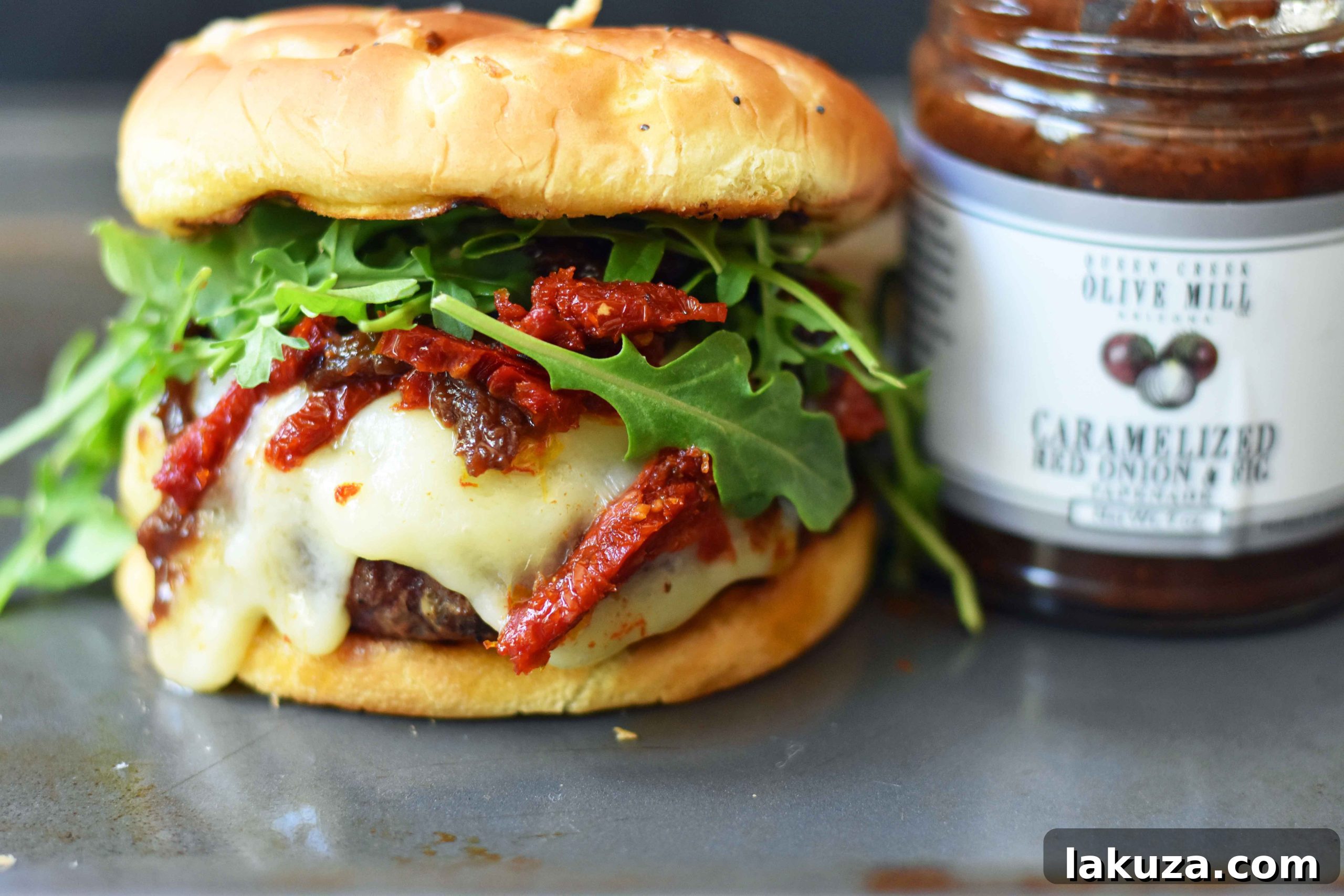 Decadent Brie Burger with Caramelized Onions and Sun-Dried Tomatoes 4 Brie Burger with Caramelized Onions and Sundried Tomatoes The Ultimate Burger with melted Brie Cheese, Sundried Tomatoes, Queen Creek Olive Mill Caramelized Red Onion Fig Tapenade, and Arugula. How to make the perfect burger. www.modernhoney.com