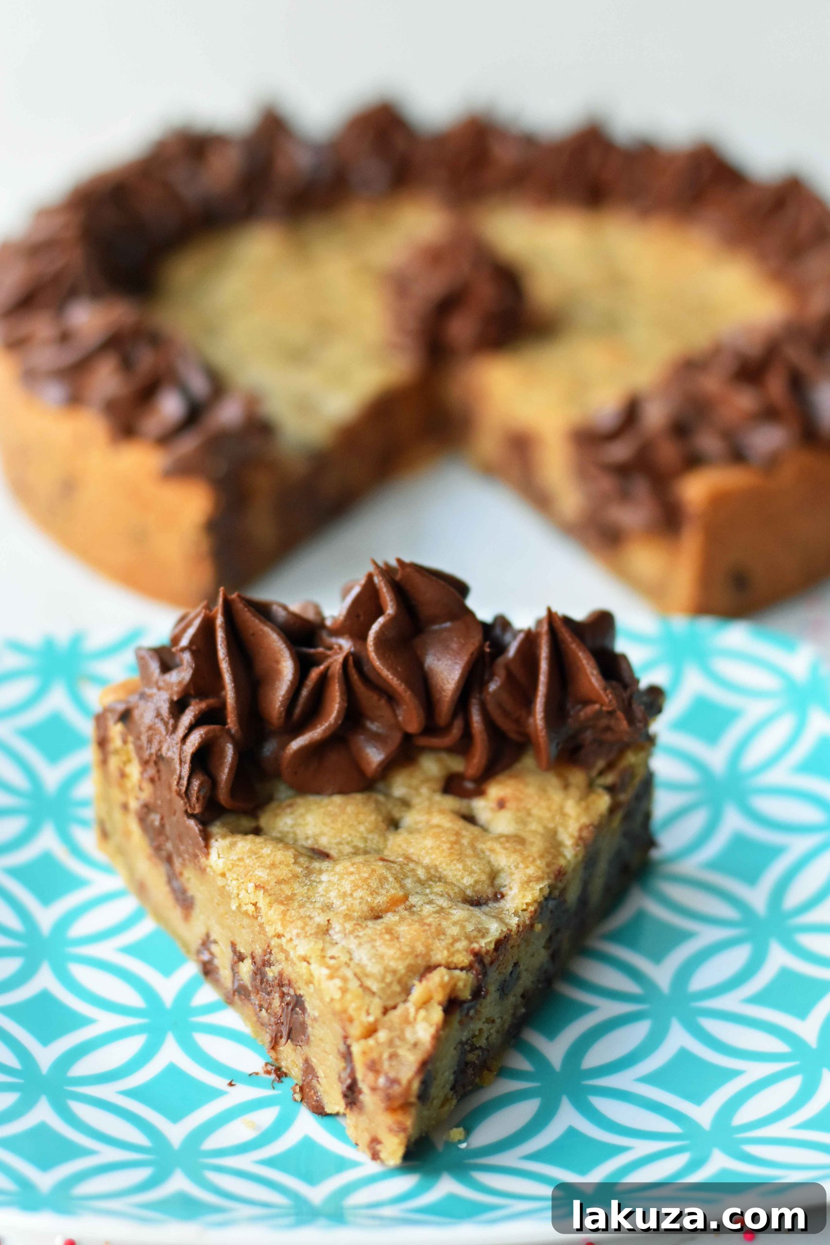 Slice of chocolate chip cookie cake showing its soft, chewy texture