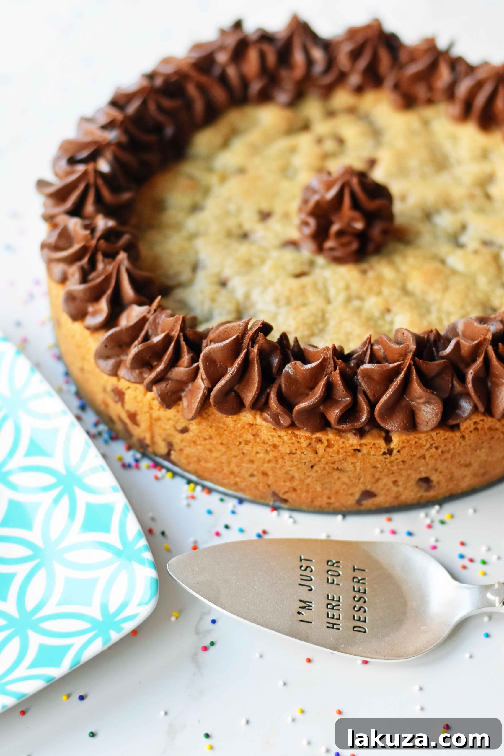 A festive cookie cake decorated with vibrant frosting and sprinkles, ready for a party