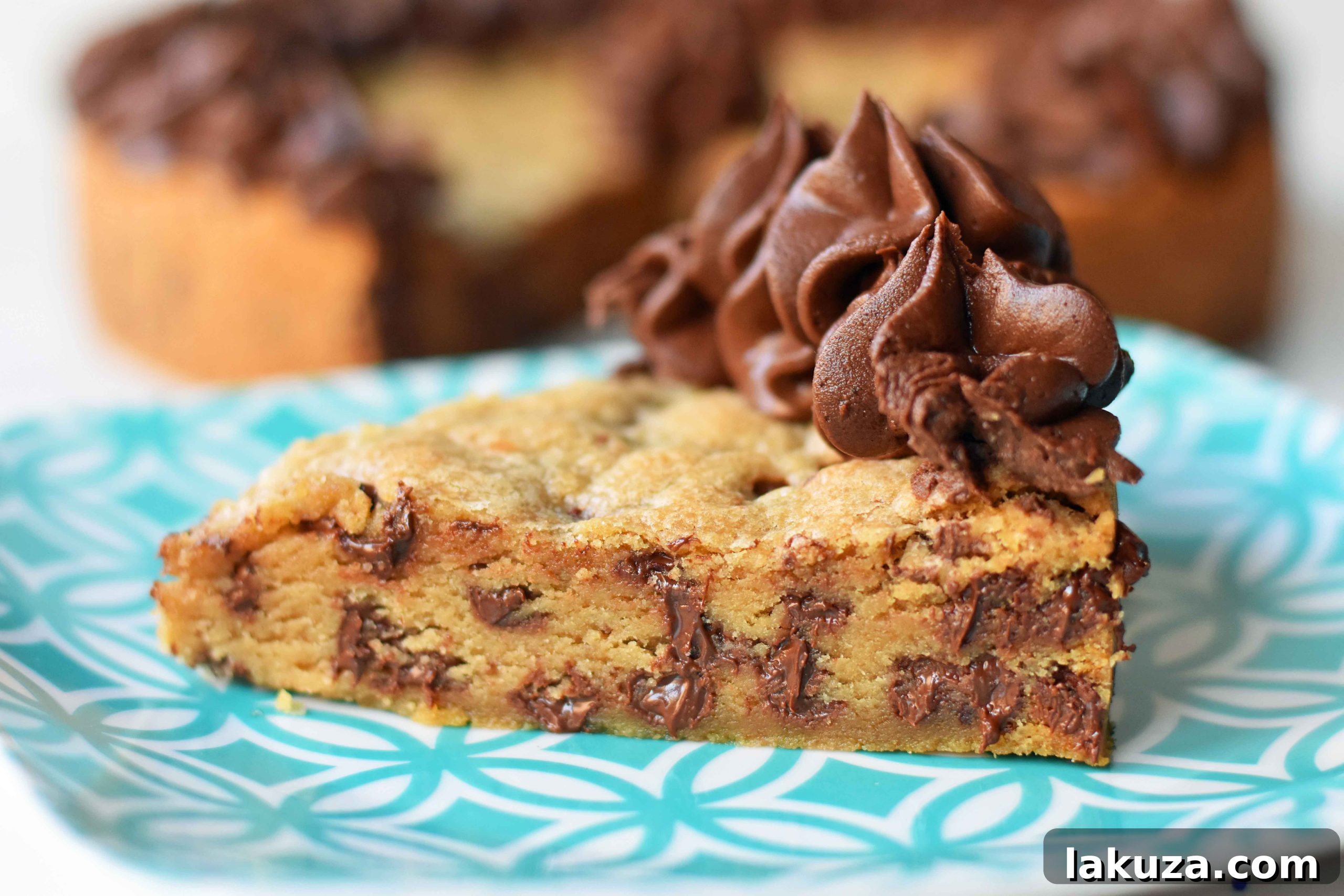 Homemade chocolate chip cookie cake with decorative frosting and a happy birthday message