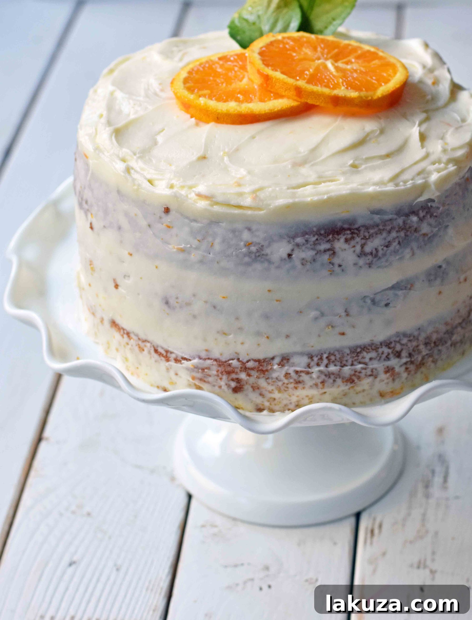 Zesty Orange Dream Cake 18 Homemade Orange Cake with Sweet Orange Cream Cheese Frosting. How to make the best orange cake. Orange cake with orange frosting. Naked orange cake. www.modernhoney.com #cake #orangecake #nakedcake #nakedorangecake