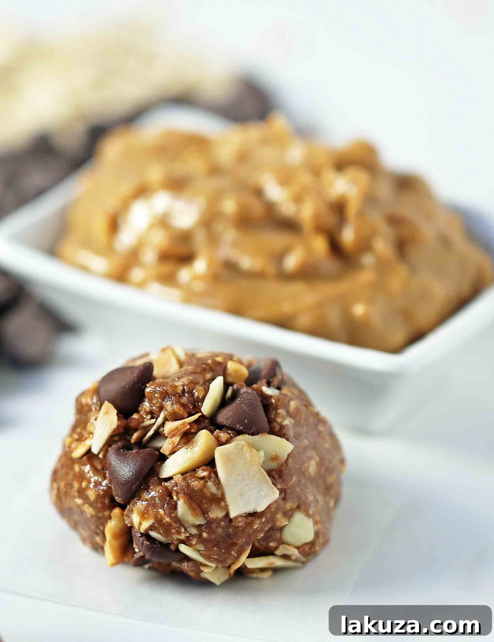 Close-up of a stack of no-bake protein energy balls, showcasing the texture and delicious add-ins like chocolate chips and oats. A perfect healthy snack.