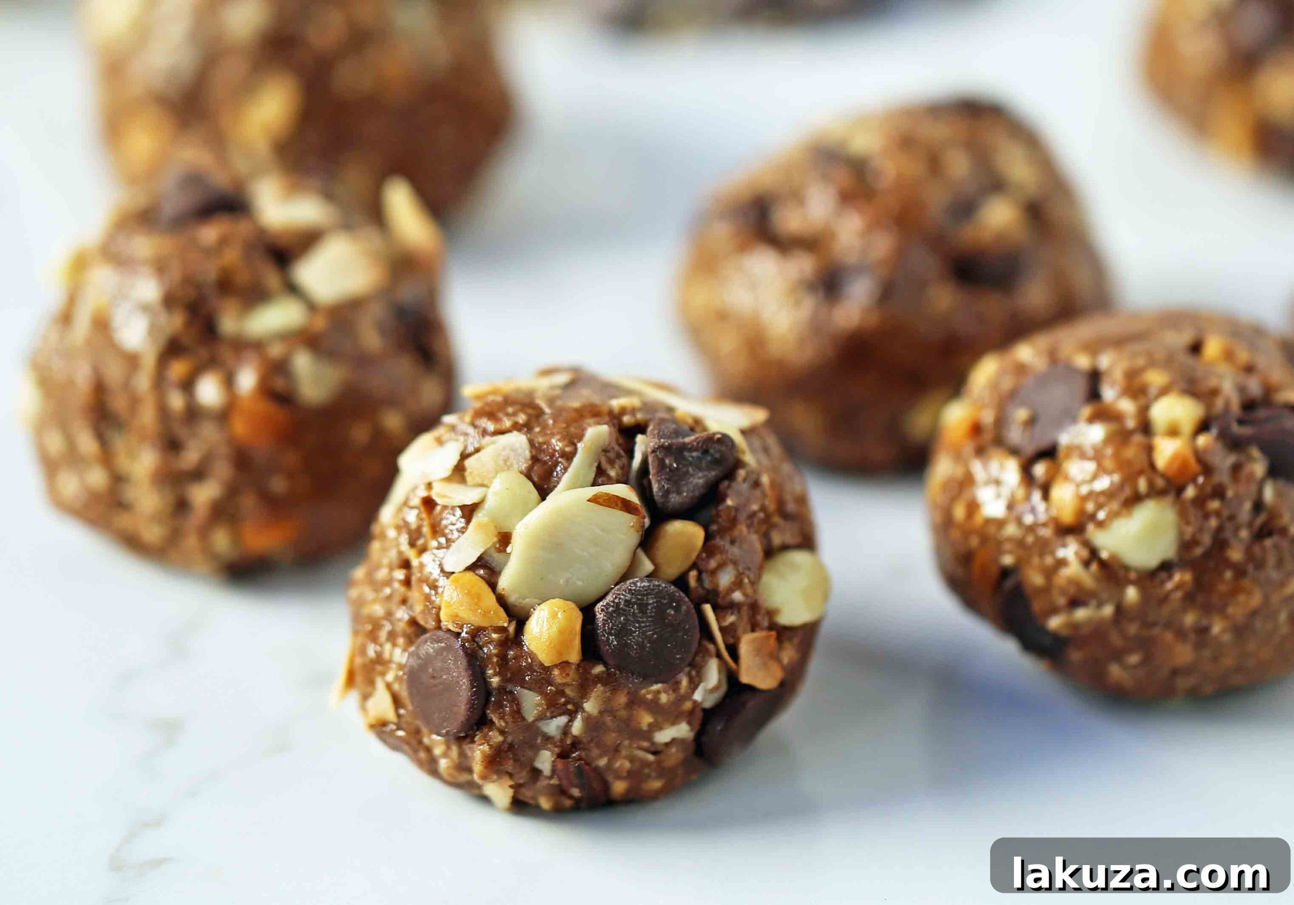 An array of delicious no-bake protein energy balls arranged on a wooden board, ready to be enjoyed as a healthy and filling snack.