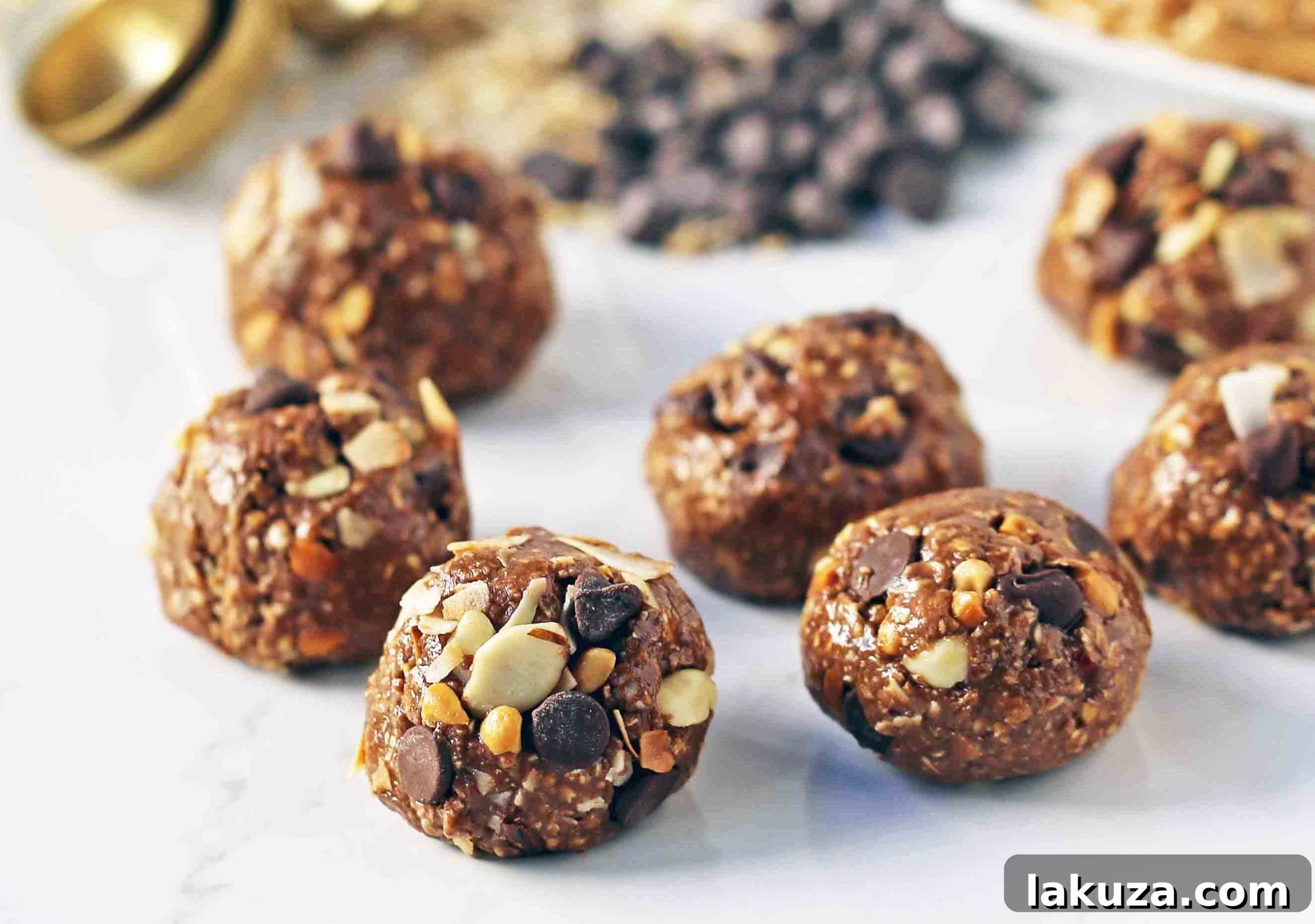Various ingredients for no-bake protein energy balls laid out, including oats, peanut butter, chocolate chips, and coconut flakes, highlighting their natural goodness.