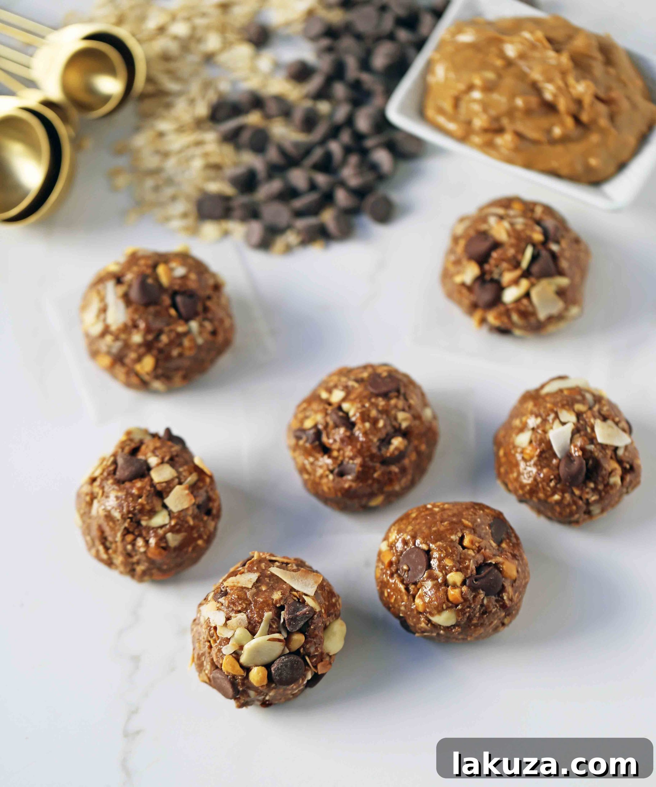 A selection of no-bake protein energy balls featuring different flavors like chocolate peanut butter and almond joy, displayed on a serving platter.