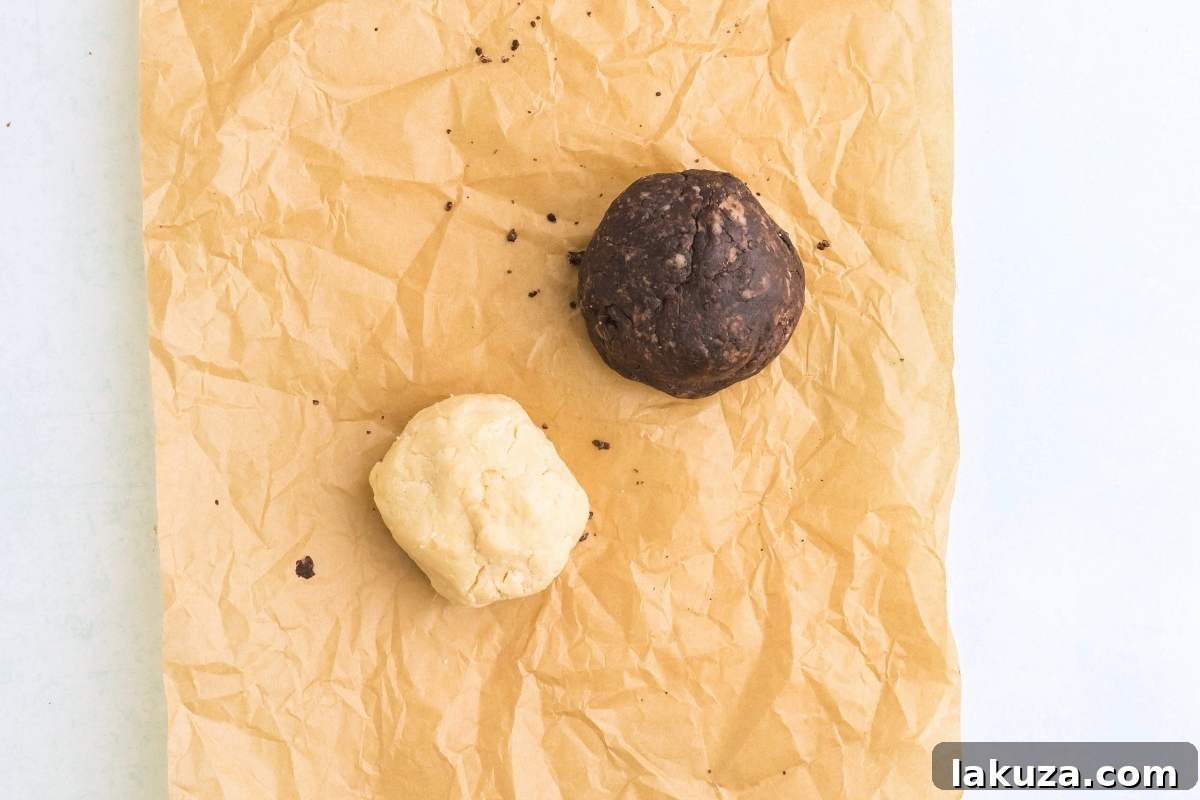 Two divided portions of dough, one plain and the other perfectly mixed with cocoa powder, ready for marbling.