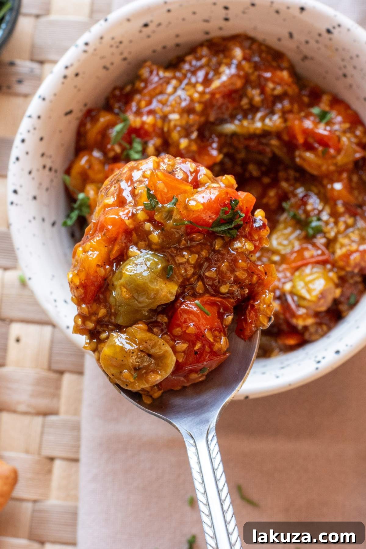 Sweet & Savory Tomato Jam 2 Bowl of tomato jam with herbs on top.