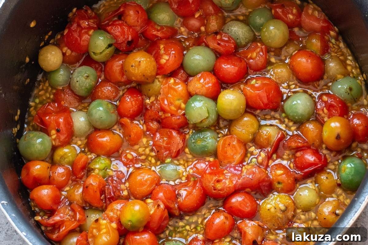 Sweet & Savory Tomato Jam 6 Tomatoes simmering in liquid in a pot.