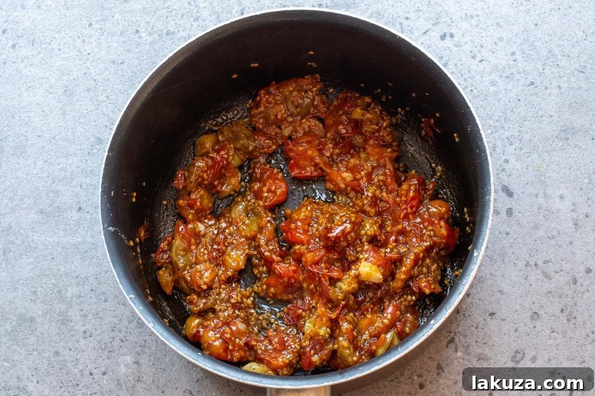 Sweet & Savory Tomato Jam 7 Cooked tomato jam in a saucepan.