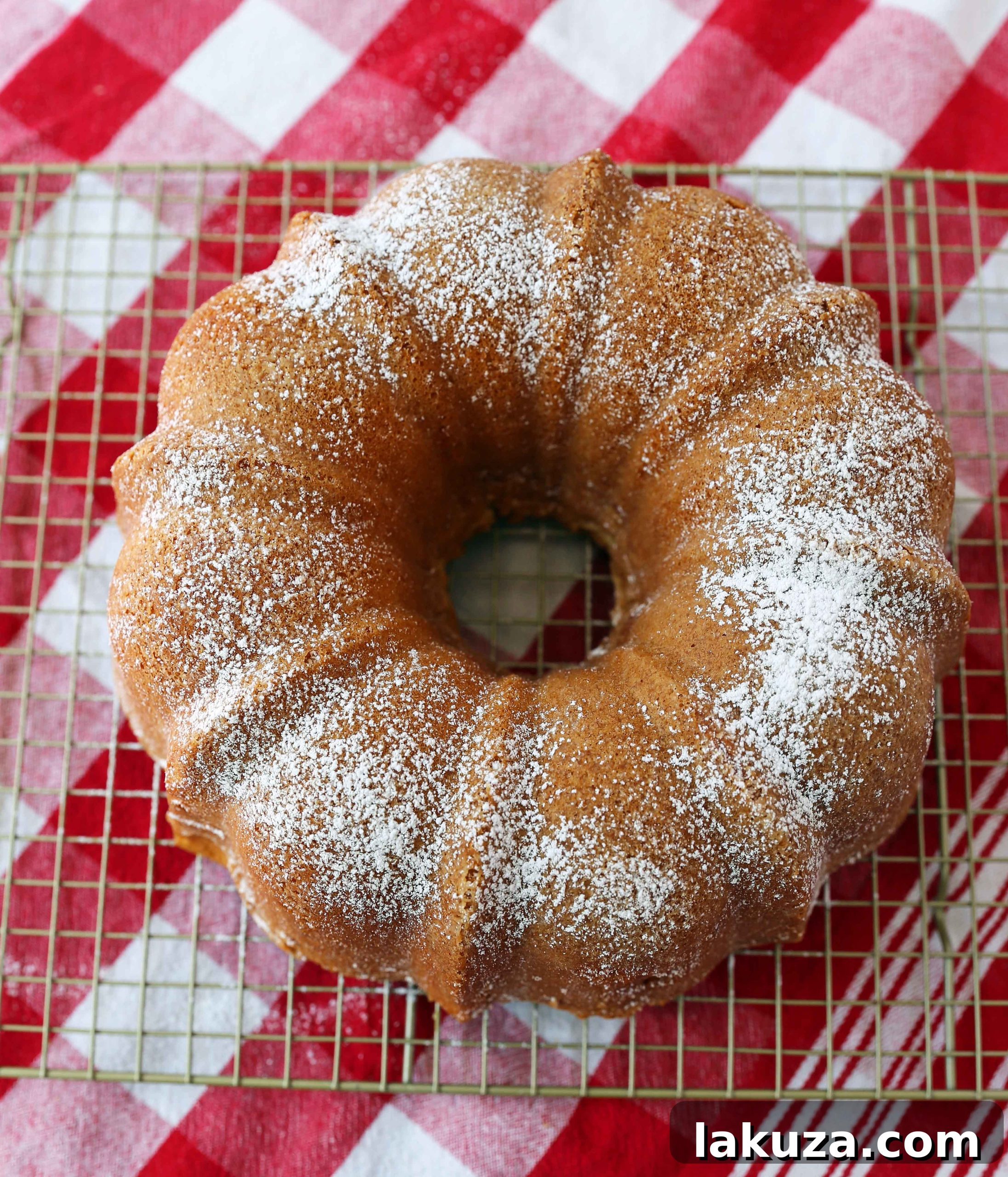 How to make the perfect buttery cream cheese pound cake in a bundt pan, served with fresh berries and whipped cream. A popular and versatile cake for any occasion.