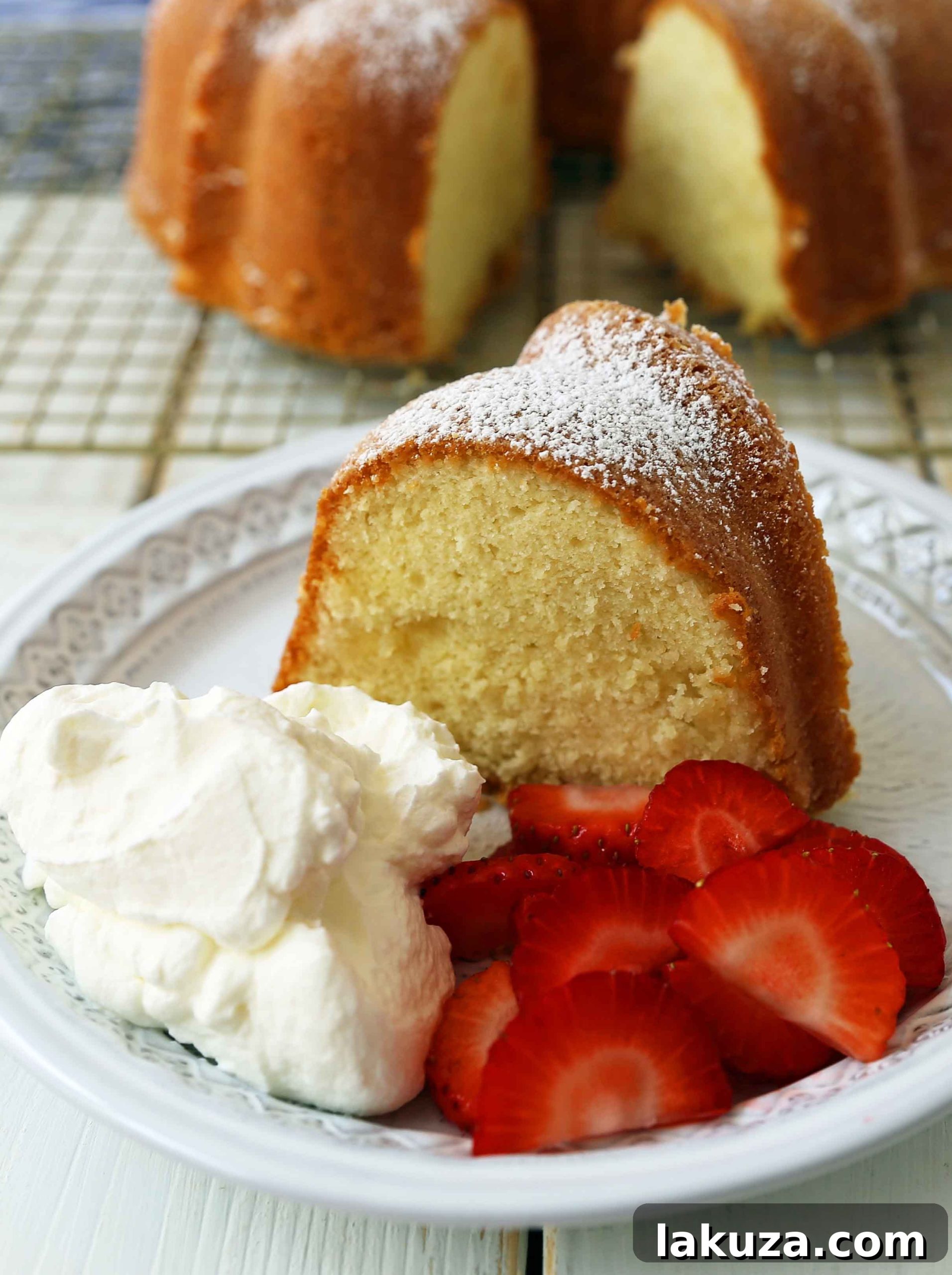 Close-up of a slice of cream cheese pound cake with a perfect crumb, ready to be served.