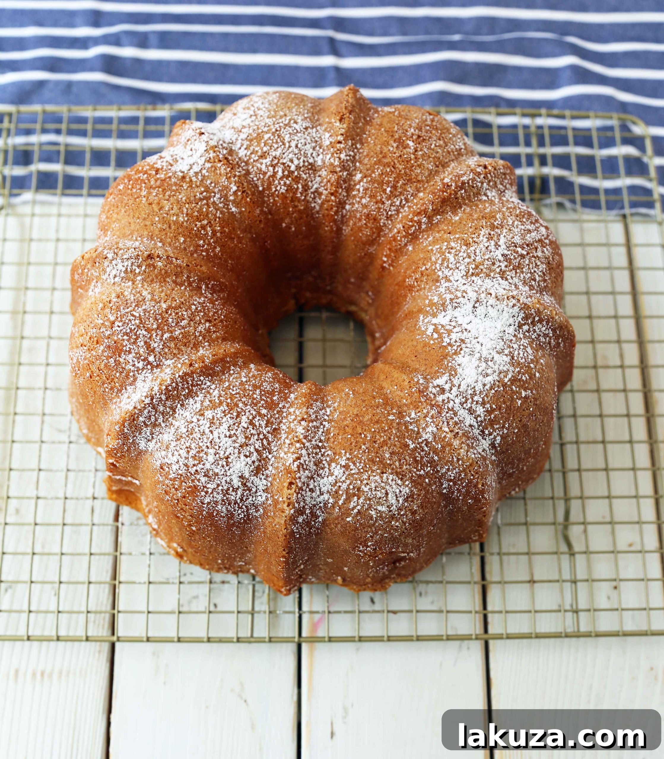 A perfectly baked cream cheese pound cake, inverted onto a cooling rack after baking in a bundt pan.