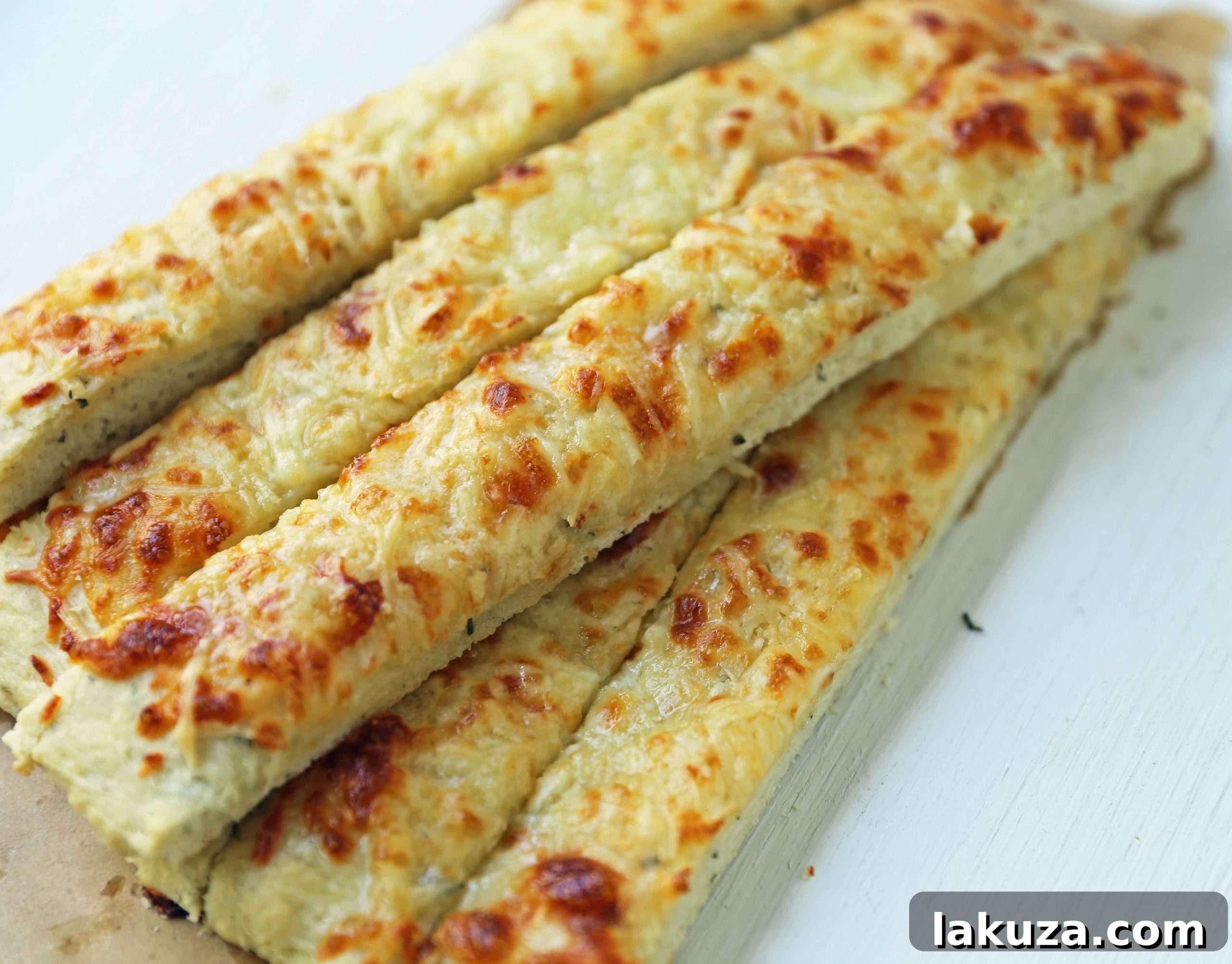 How to make phenomenal Cheese Focaccia Bread with garlic. Step-by-step guide to the best homemade focaccia. Perfect for cheesy breadsticks or squares. www.modernhoney.com #focaccia