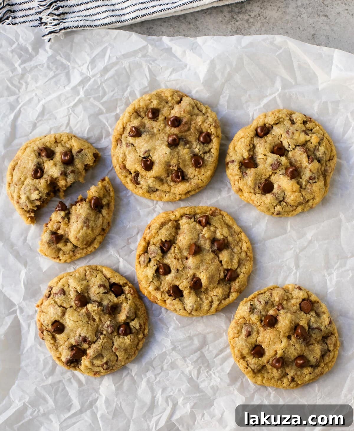 A stack of golden brown chocolate chip oatmeal cookies on a plate, ready to be served.