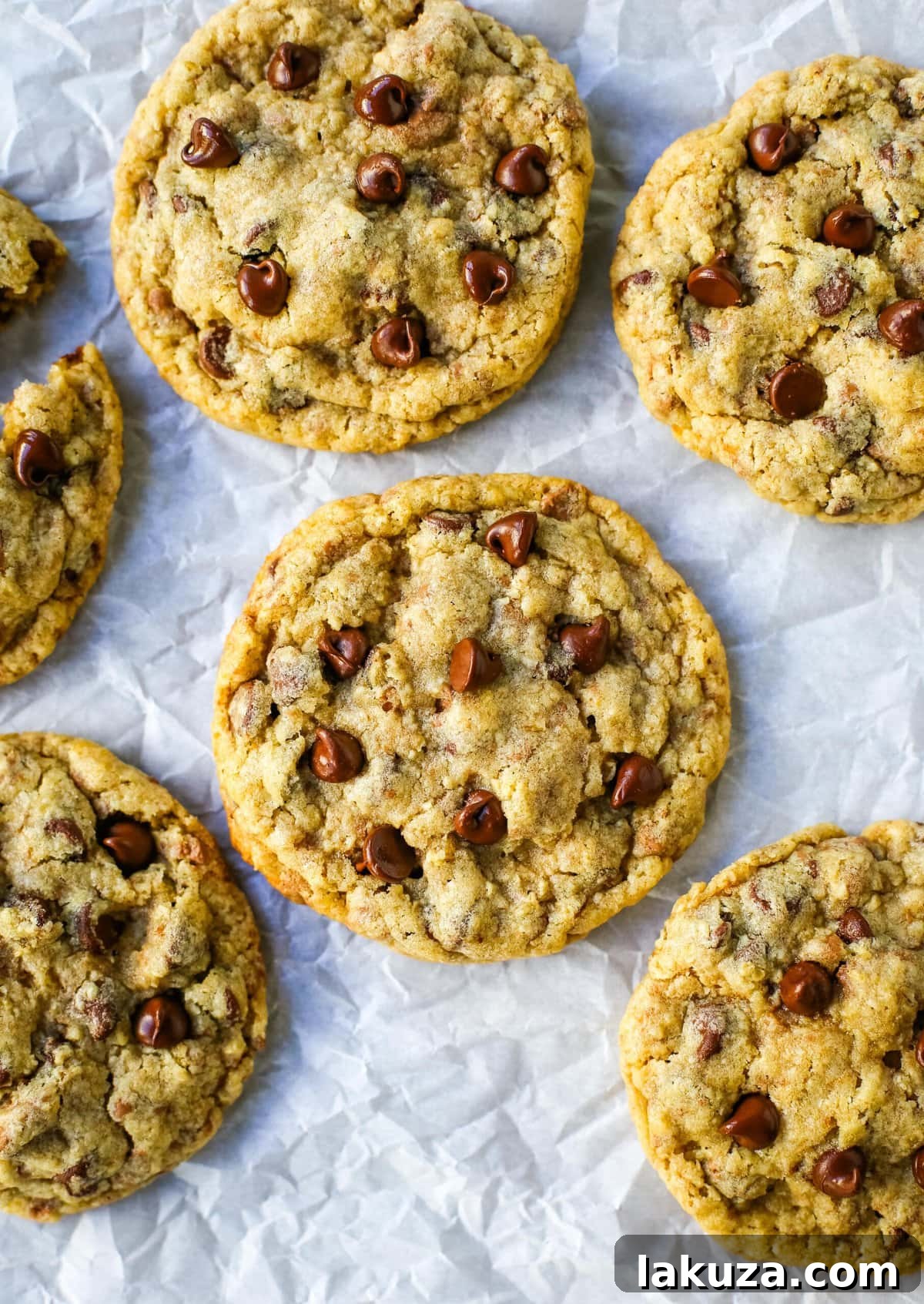 A plate of chocolate chip oatmeal cookies with a glass of milk, capturing the classic pairing.