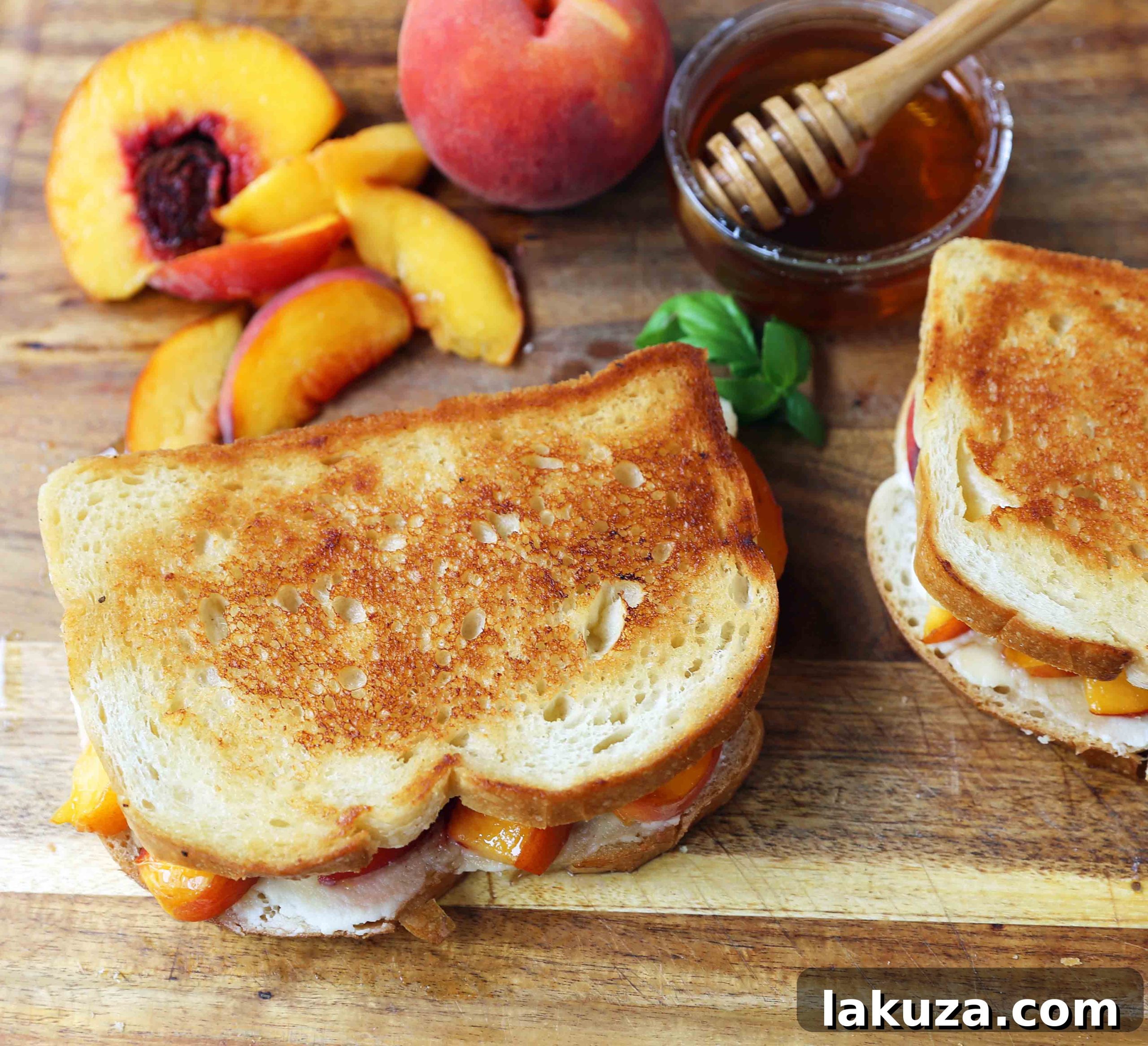 Detailed shot of the inside of a Honey Peach White Cheddar Grilled Cheese, highlighting the layers of sourdough bread, creamy ricotta, sharp white cheddar, and tender peach slices.