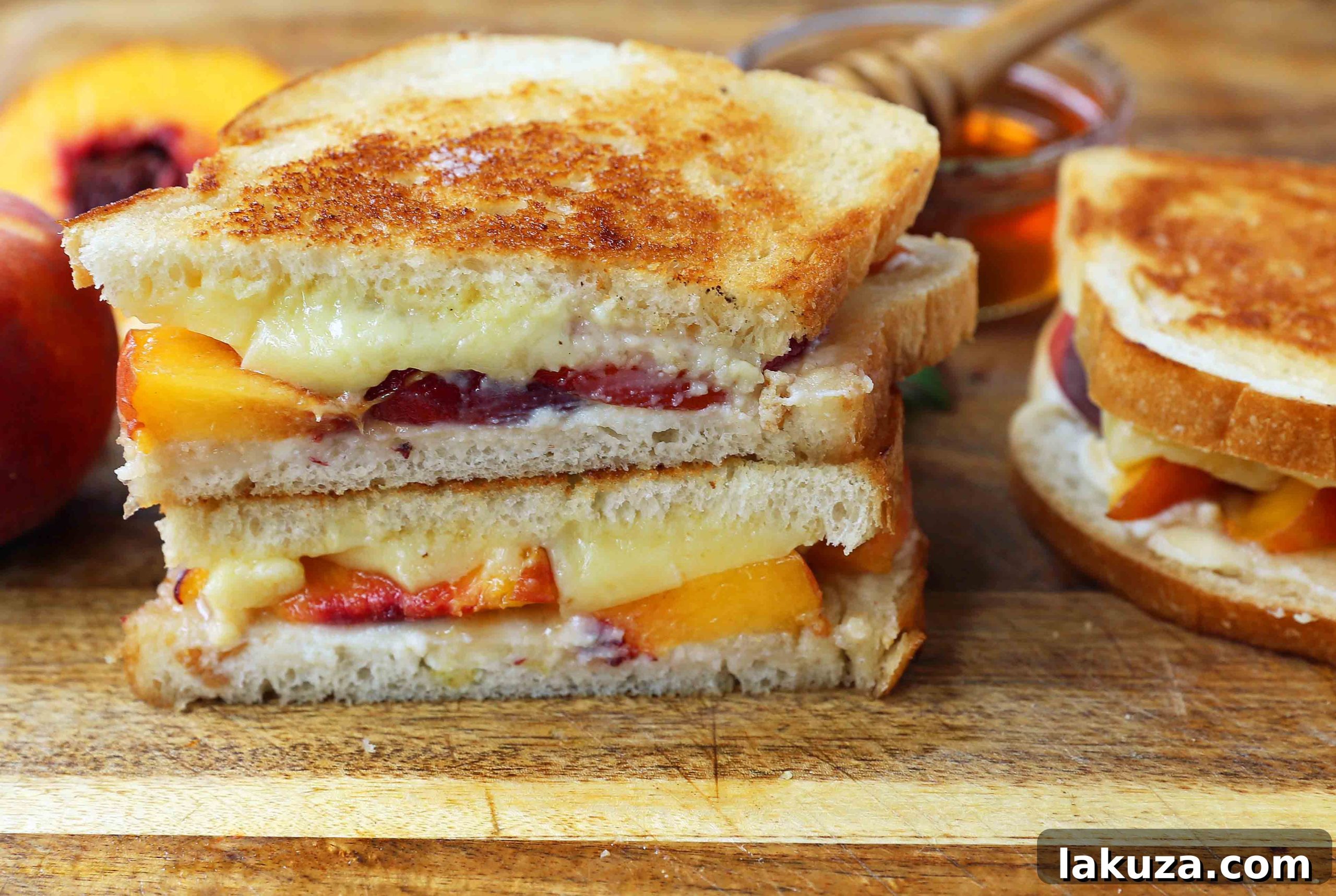 Variety of cheeses perfect for grilled cheese: blocks and slices of white cheddar, medium cheddar, and Monterey Jack, indicating excellent melting qualities.