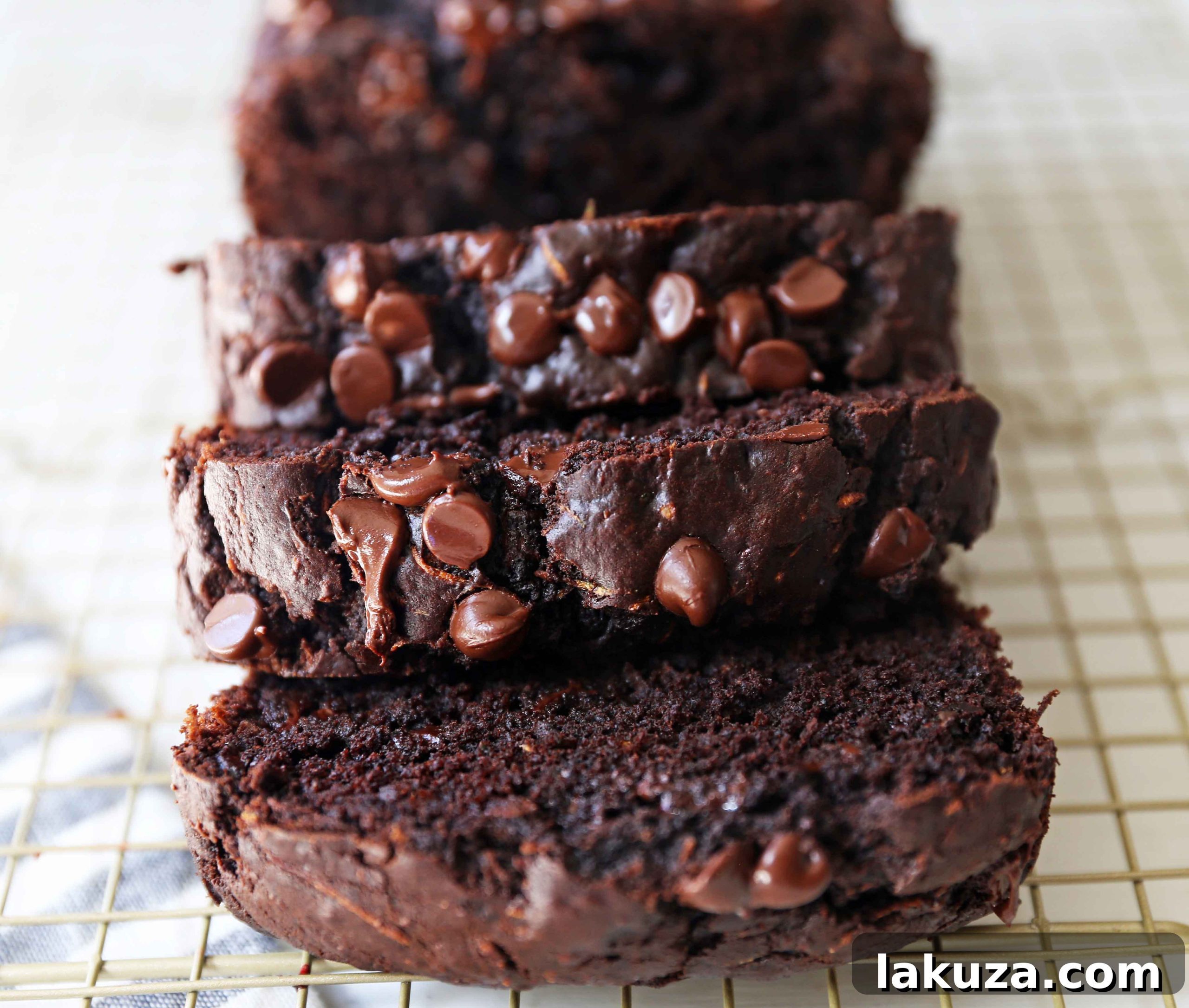 Chocolate Zucchini Bread. A rich double chocolate zucchini bread with chocolate chips recipe. You will never know there is zucchini in this chocolate bread! It is moist, rich, and a chocolate lover's dream! www.modernhoney.com #zucchinibread #chocolatezucchinibread #zucchinirecipes