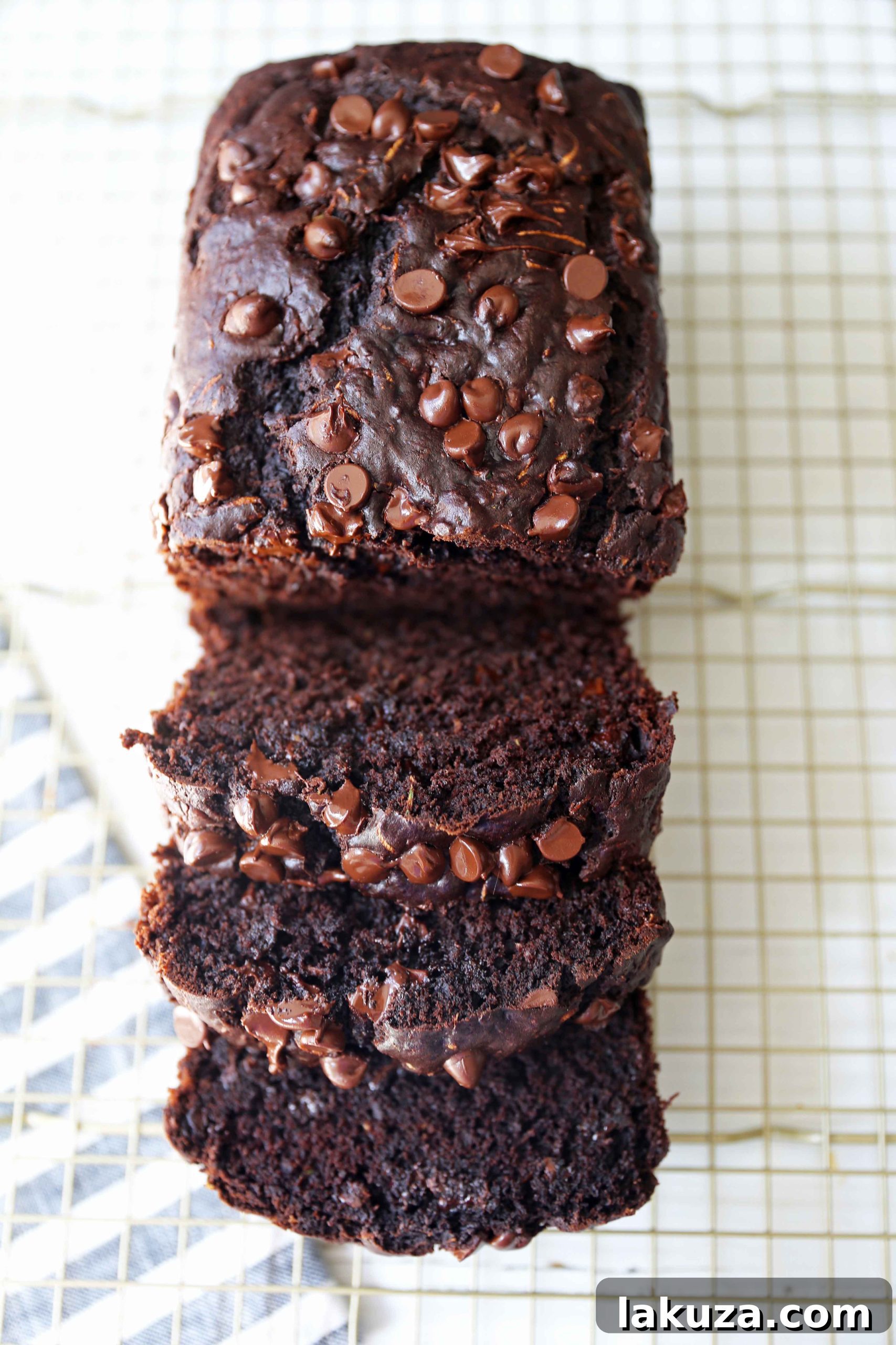 Chocolate Zucchini Bread. A rich double chocolate zucchini bread with chocolate chips recipe. You will never know there is zucchini in this chocolate bread! It is moist, rich, and a chocolate lover's dream! www.modernhoney.com #zucchinibread #chocolatezucchinibread #zucchinirecipes