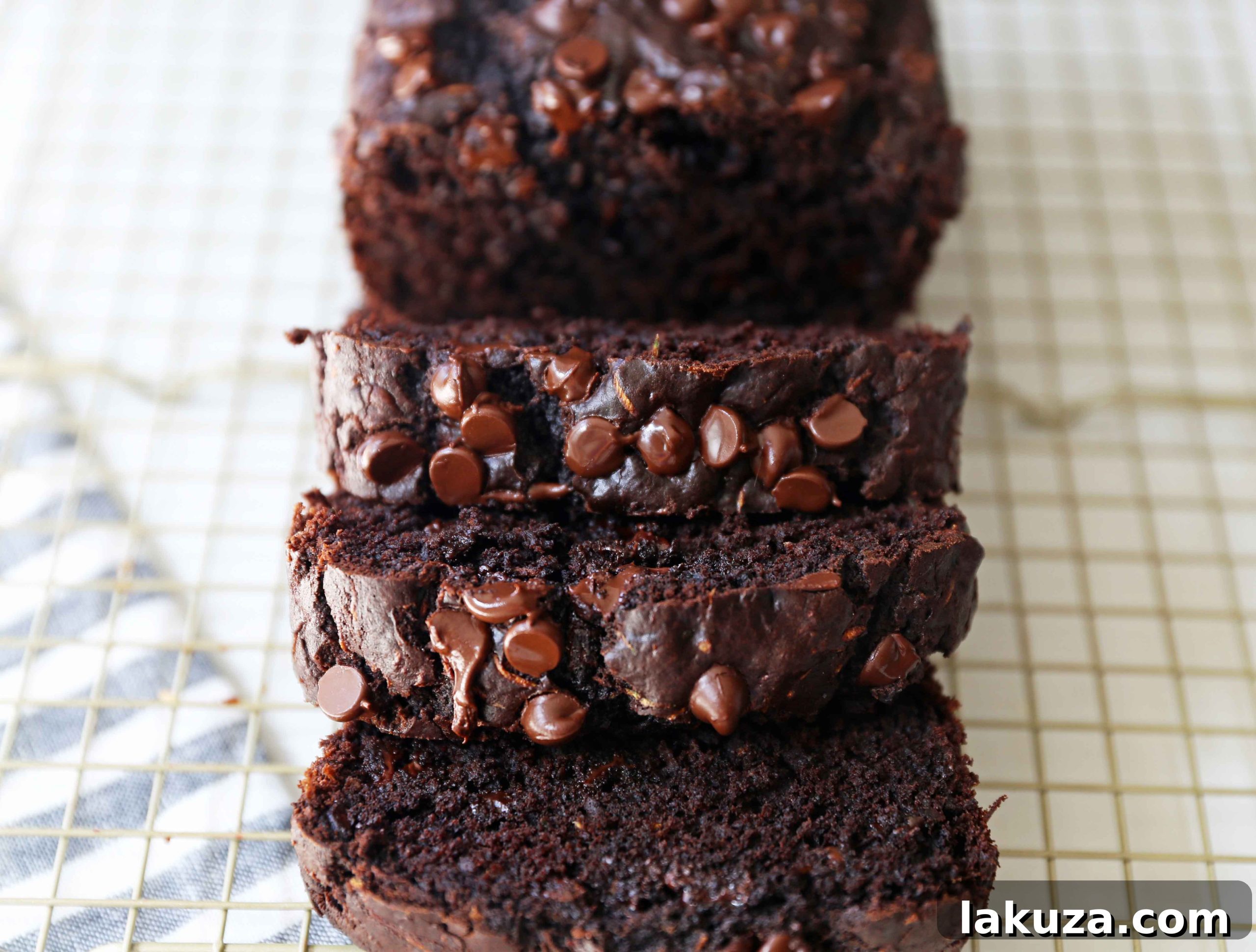Chocolate Zucchini Bread. A rich double chocolate zucchini bread with chocolate chips recipe. You will never know there is zucchini in this chocolate bread! It is moist, rich, and a chocolate lover's dream! www.modernhoney.com #zucchinibread #chocolatezucchinibread #zucchinirecipes
