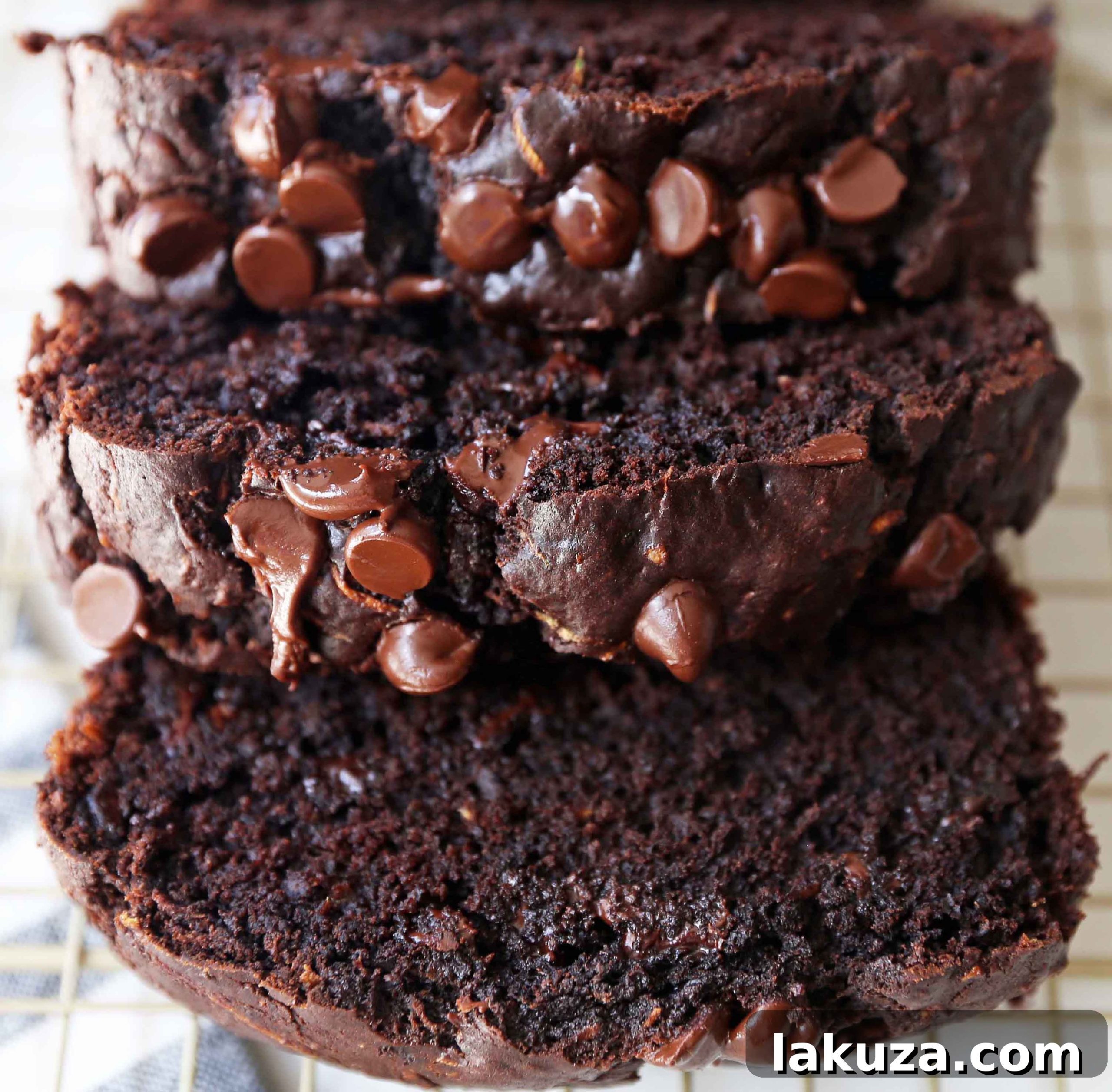 Chocolate Zucchini Bread. A rich double chocolate zucchini bread with chocolate chips recipe. You will never know there is zucchini in this chocolate bread! It is moist, rich, and a chocolate lover's dream! www.modernhoney.com #zucchinibread #chocolatezucchinibread #zucchinirecipes