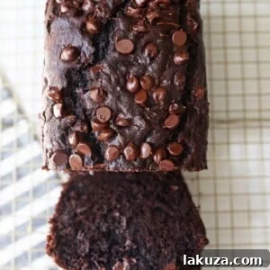Chocolate Zucchini Bread. A rich double chocolate zucchini bread with chocolate chips recipe. You will never know there is zucchini in this chocolate bread! It is moist, rich, and a chocolate lover's dream! www.modernhoney.com #zucchinibread #chocolatezucchinibread #zucchinirecipes