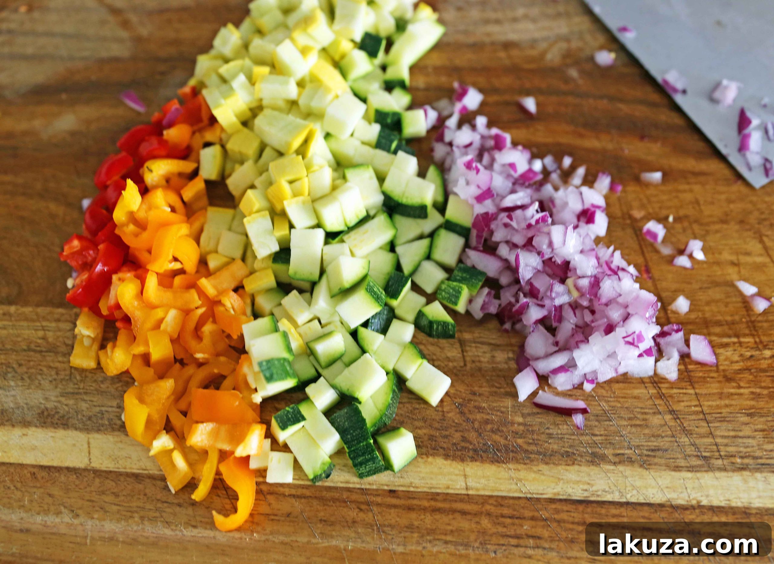 Assortment of vibrant vegetables including bell peppers, zucchini, squash, and red onion, prepped for a delicious veggie quesadilla.