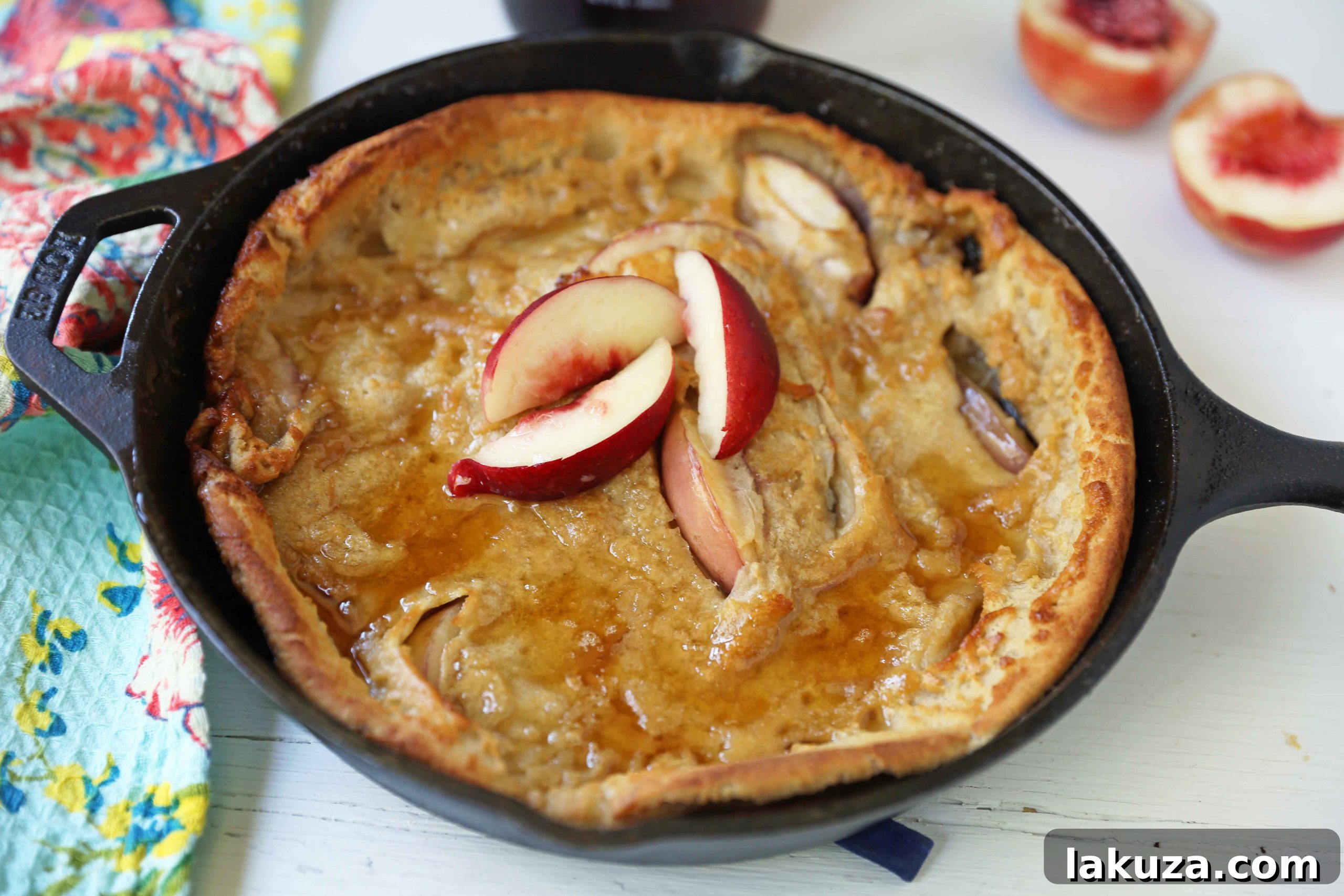 Caramelized Brown Sugar Peach Dutch Baby 4 Ingredients for Brown Sugar Peach Dutch Baby laid out on a table, including peaches, butter, and batter