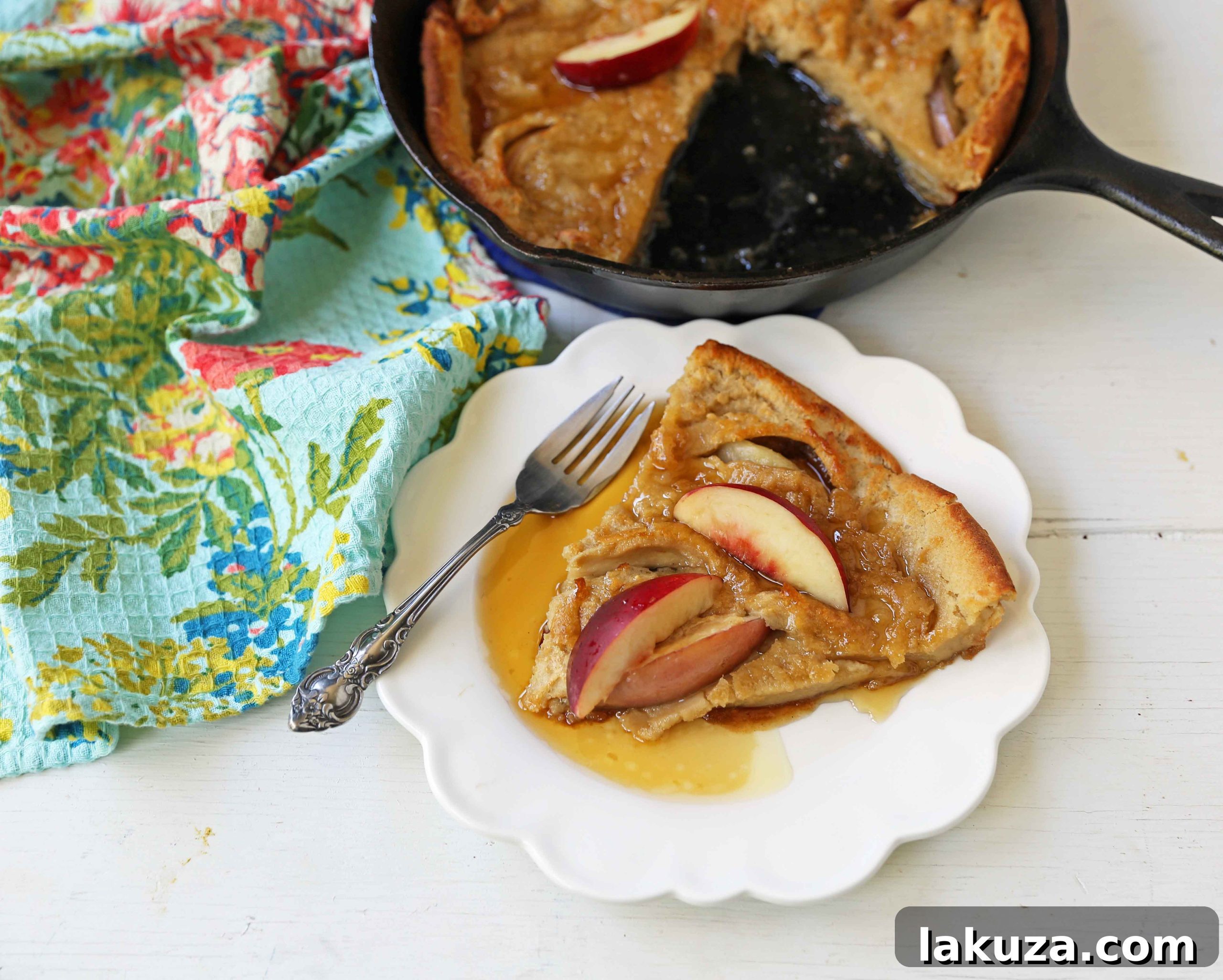 Caramelized Brown Sugar Peach Dutch Baby 5 A slice of Brown Sugar Peach Dutch Baby topped with fresh peaches, whipped cream, and a dusting of powdered sugar