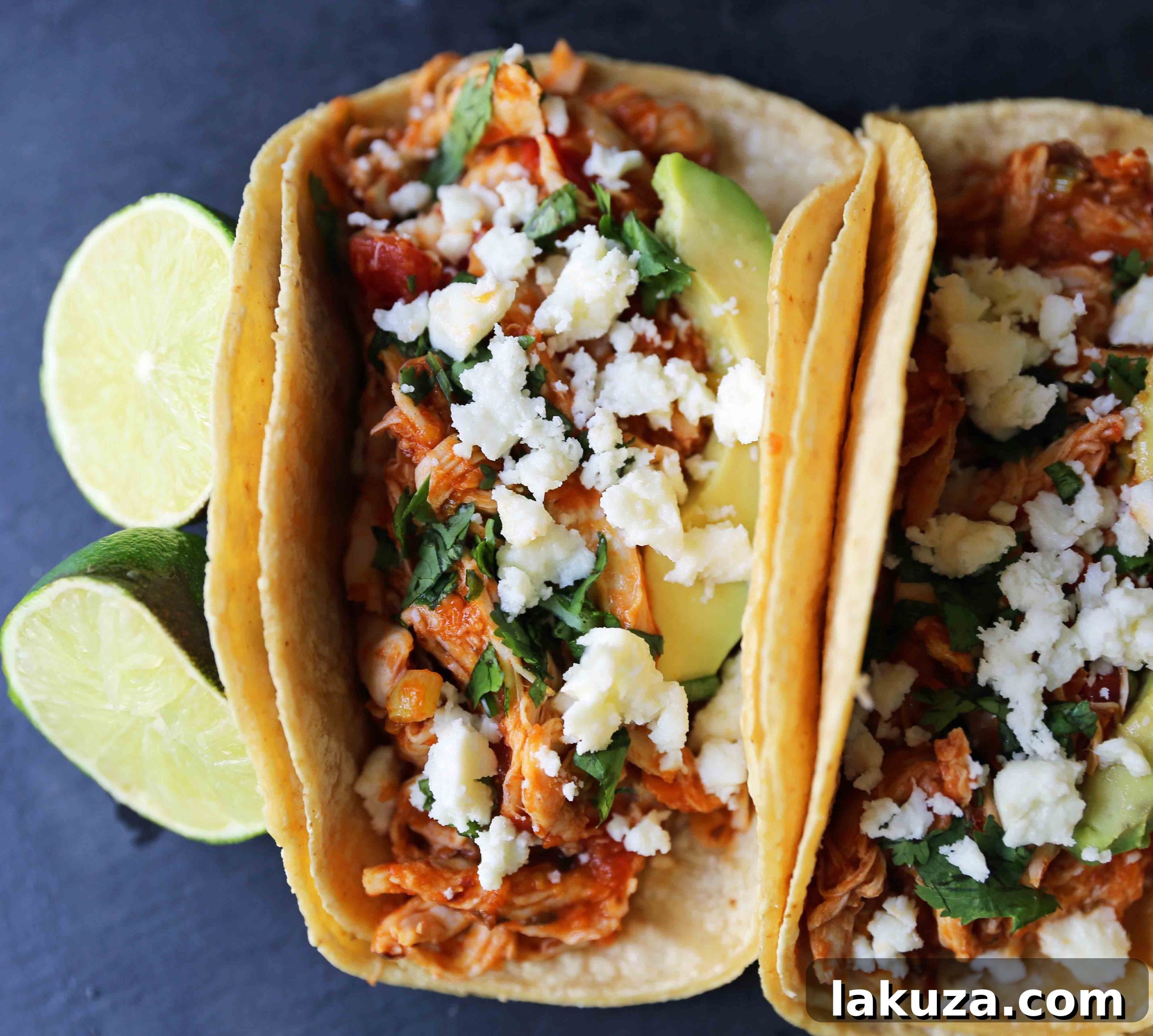 A vibrant close-up of the shredded Chipotle Chicken Tinga mixture, glistening in its rich, red sauce, ready to be served in warm tortillas. This one-skillet chicken taco recipe is quick, simple, and packed with flavor.