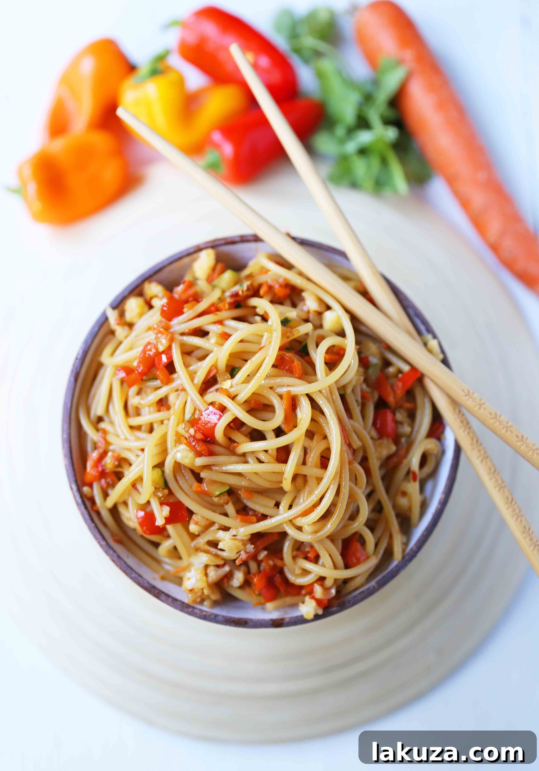 Vibrant Asian Noodle Stir-Fry 5 Freshly cooked Asian Vegetable Stir-Fry Noodles in a serving bowl. Healthy vegetables tossed with noodles and a homemade stir-fry sauce. A delicious, quick, and easy 20-minute family dinner, Asian Garlic Noodles Recipe. www.modernhoney.com #asiannoodles #garlicnoodles #stirfry #veggiestirfry #asianfood #familymeals