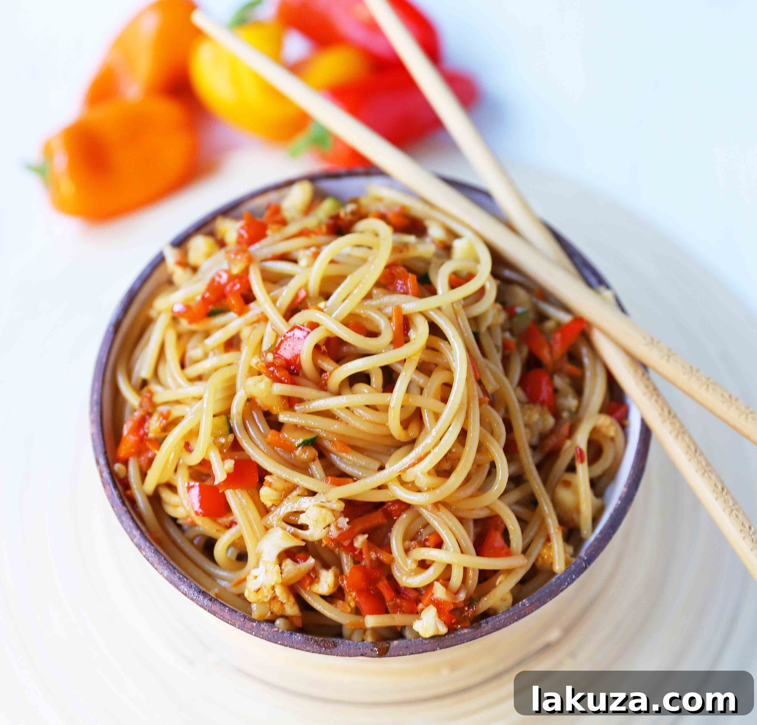 Vibrant Asian Noodle Stir-Fry 6 Serving of Asian Vegetable Stir-Fry Noodles in a white bowl with chopsticks. A healthy, quick, and easy family dinner featuring fresh vegetables and homemade stir-fry sauce with noodles. 20-minute Asian Garlic Noodles Recipe from Modern Honey. www.modernhoney.com #asiannoodles #garlicnoodles #stirfry #veggiestirfry #asianfood #healthyrecipes
