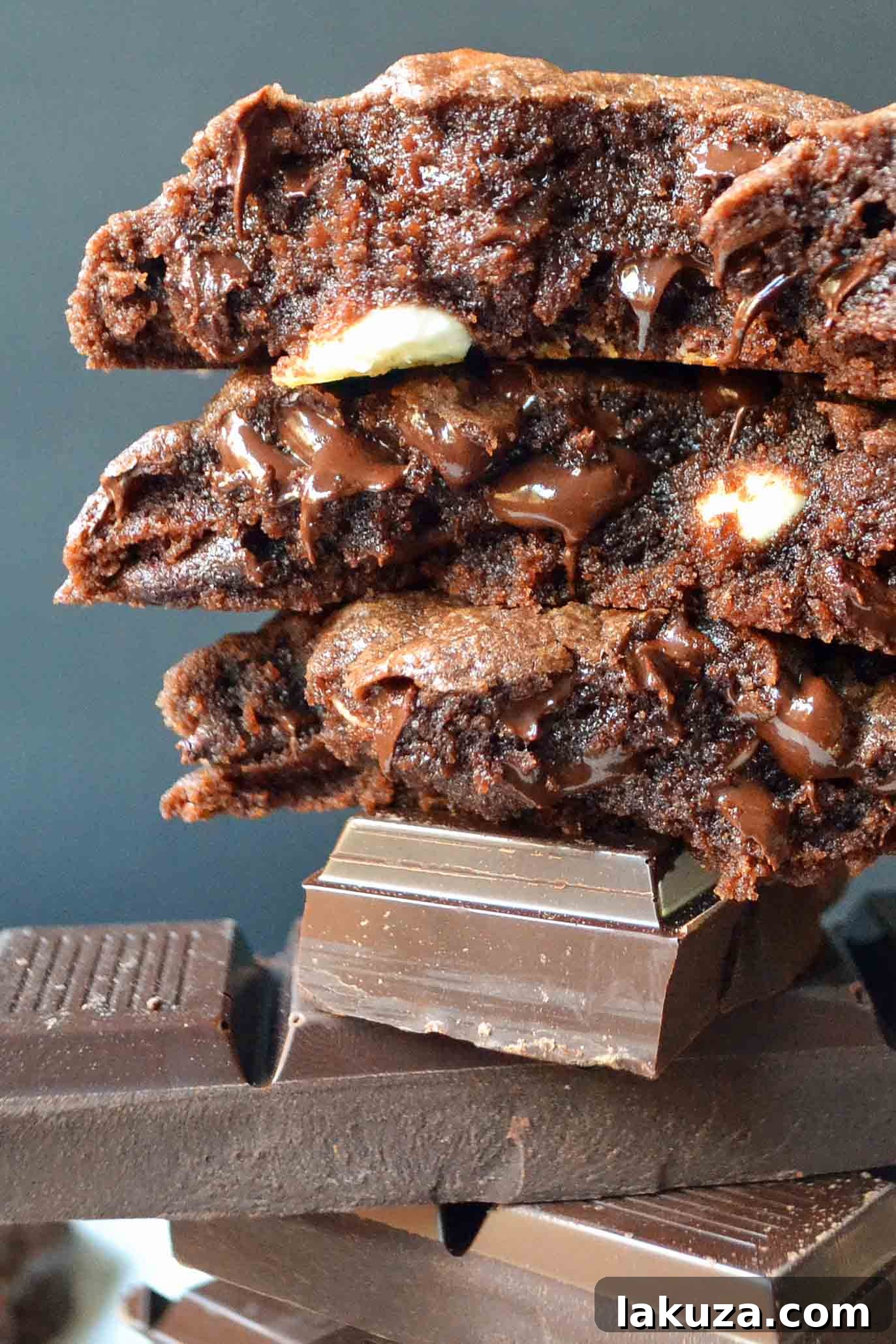 Close-up of a warm, soft Triple Chocolate Cookie with visible chocolate chunks