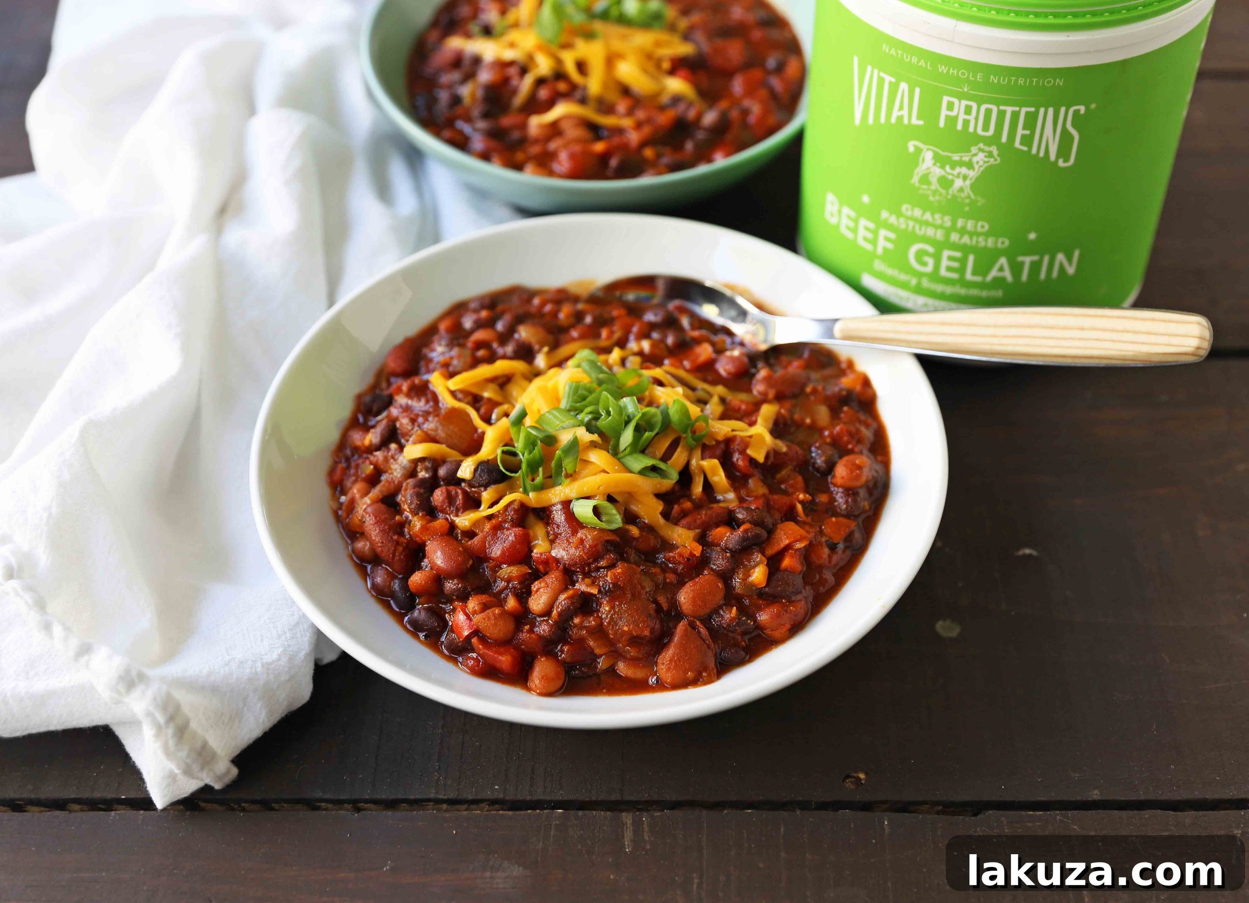 Fiber-Rich Veggie Chili: A close-up of healthy vegetarian chili, highlighting the generous mix of pinto, kidney, and black beans, along with vibrant vegetables, illustrating the dish's robust texture and nutritional value.