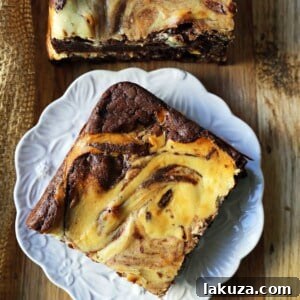 Cheesecake Brownies with a beautiful cream cheese swirl. Perfect homemade dessert bar recipe.