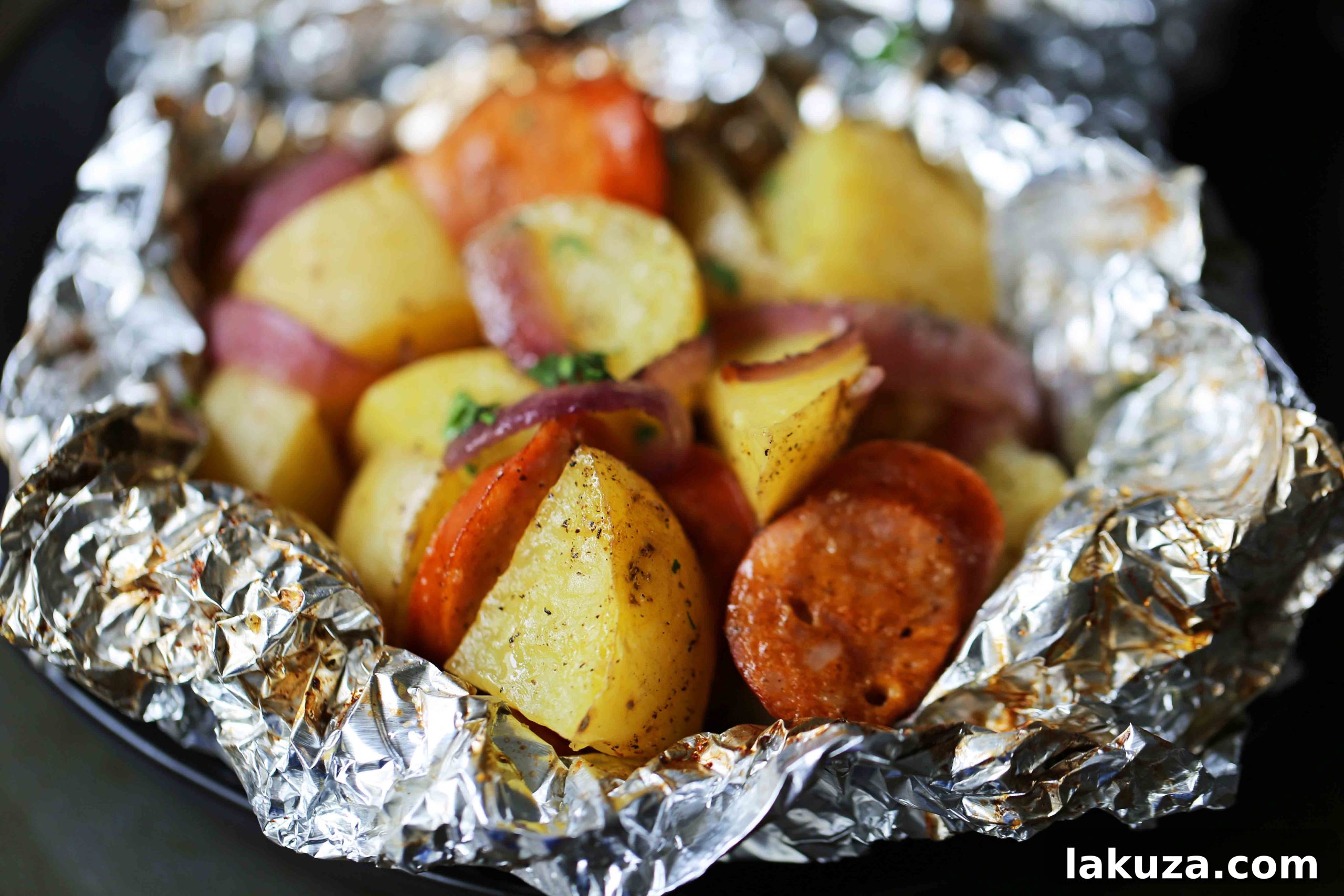 Hearty Sausage and Potato Foil Meals 3 Cooked Sausage Potato Foil Packets with golden brown smoked sausage and tender, creamy gold potatoes, presented on a plate. An easy and flavor-packed dinner cooked in the oven or on the grill, perfect for family meals. #foilpacketdinner #sausageandpotatoes #weeknightmeal #comfortfood