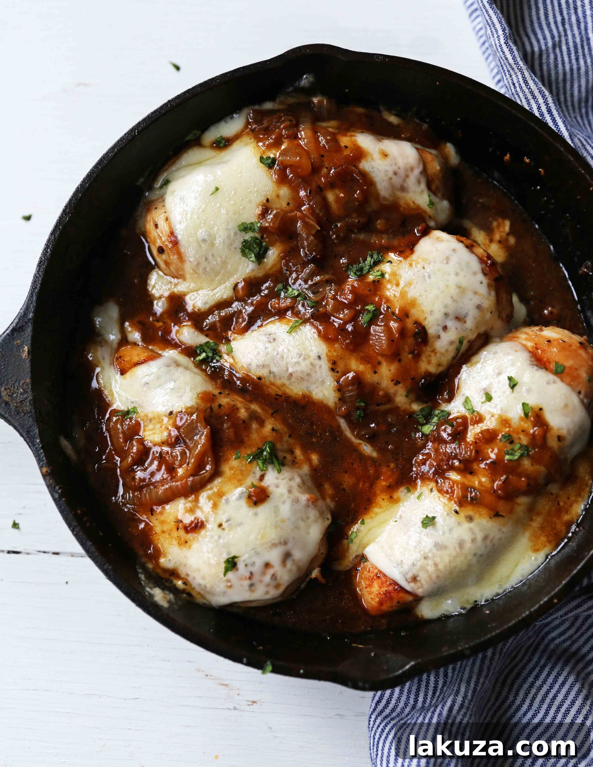 Golden French Onion Chicken 2 Delicious French Onion Chicken Skillet: Tender chicken breasts topped with buttery caramelized onions, rich gravy, and melted Provolone and Swiss cheeses. An easy, flavorful, 30-minute meal perfect for a cozy dinner. Recipe on ModernHoney.com #FrenchOnionChicken #SkilletDinner #EasyChickenRecipe #ComfortFood #30MinuteMeal #CheesyChicken