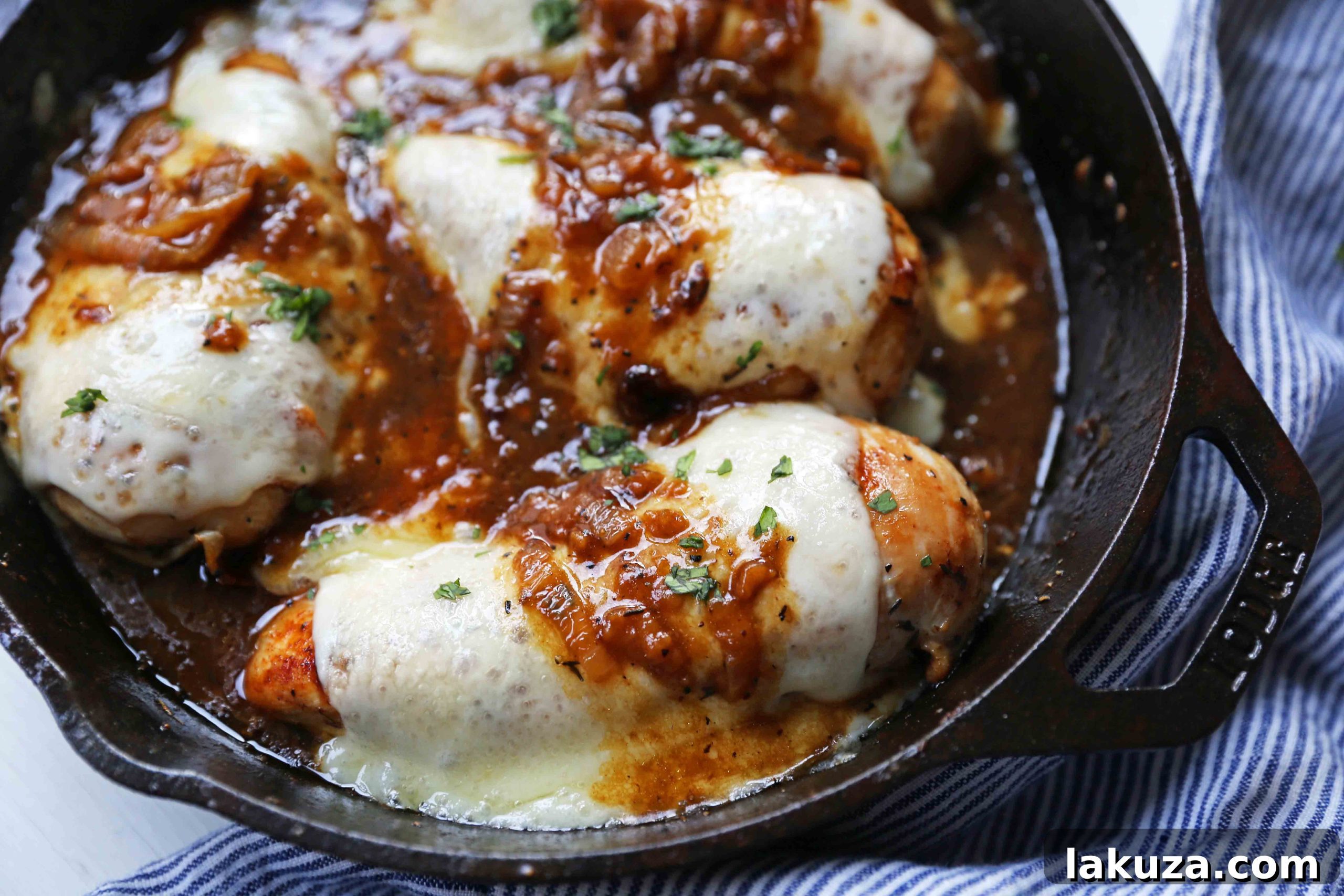 Golden French Onion Chicken 3 Skillet French Onion Chicken close-up: Juicy chicken breast smothered in golden caramelized onions and bubbling melted cheeses, ready to be served. A quick and satisfying dinner solution. #DinnerIdeas #OnePanMeal #CaramelizedOnions #CheeseLover