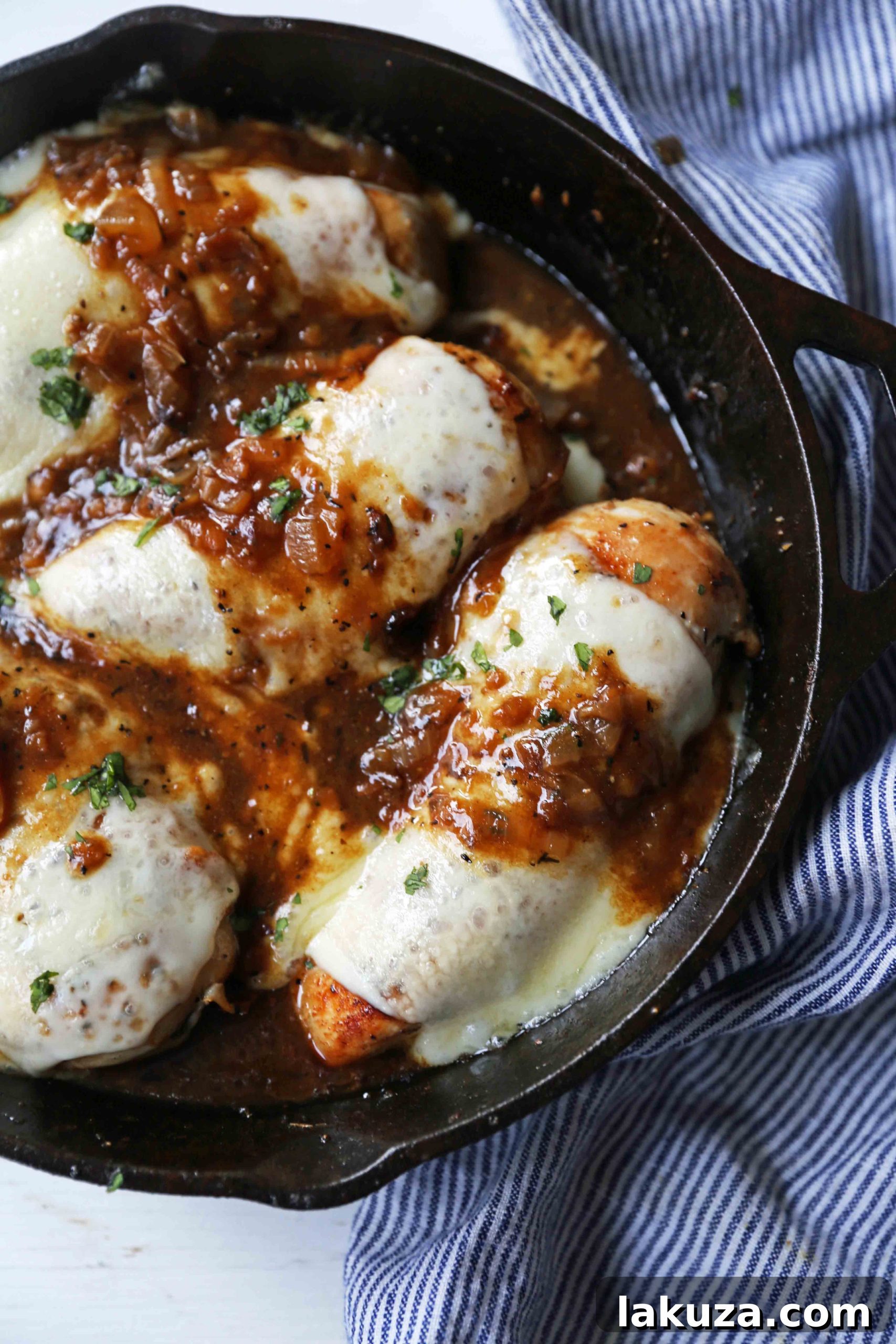Golden French Onion Chicken 7 Beautifully plated French Onion Chicken, ready to be enjoyed. The rich brown gravy, tender chicken, and melted cheese are highlighted with fresh herbs, making it an appealing dinner choice.