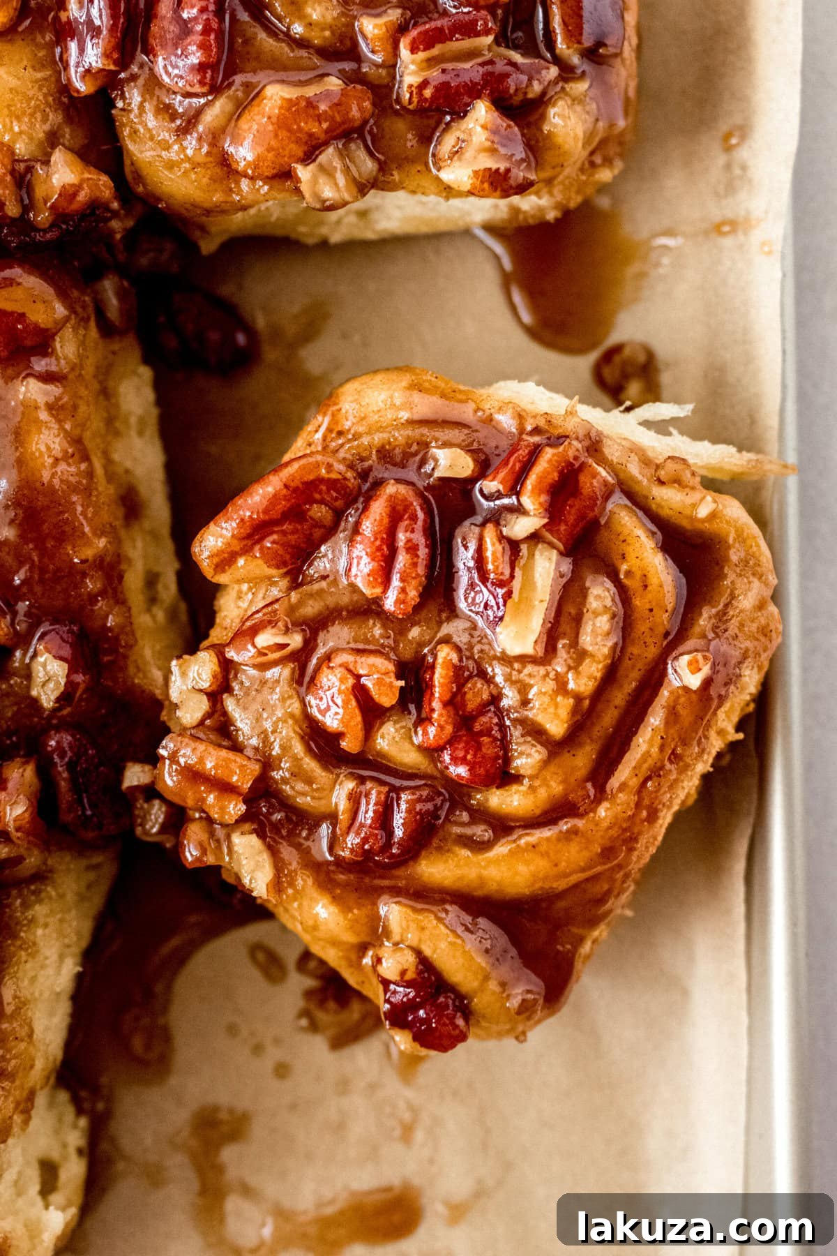 Caramel pecan sticky buns also known as caramel pecan rolls are homemade sweet rolls filled with a brown sugar cinnamon filling and topped with a rich caramel sauce and pecans. Sweet, nutty, and rich, this is the best sticky bun recipe!