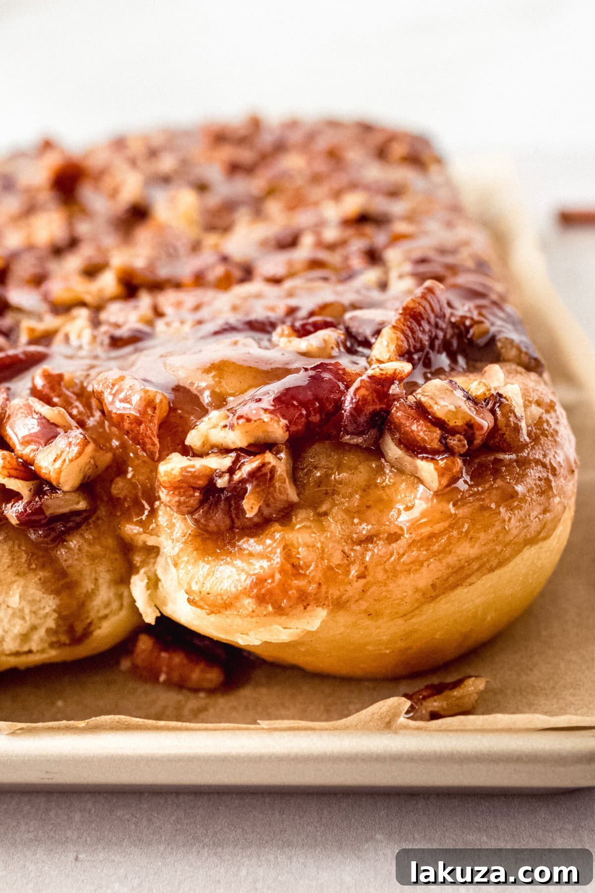 Caramel pecan sticky buns also known as caramel pecan rolls are homemade sweet rolls filled with a brown sugar cinnamon filling and topped with a rich caramel sauce and pecans. Sweet, nutty, and rich, this is the best sticky bun recipe!
