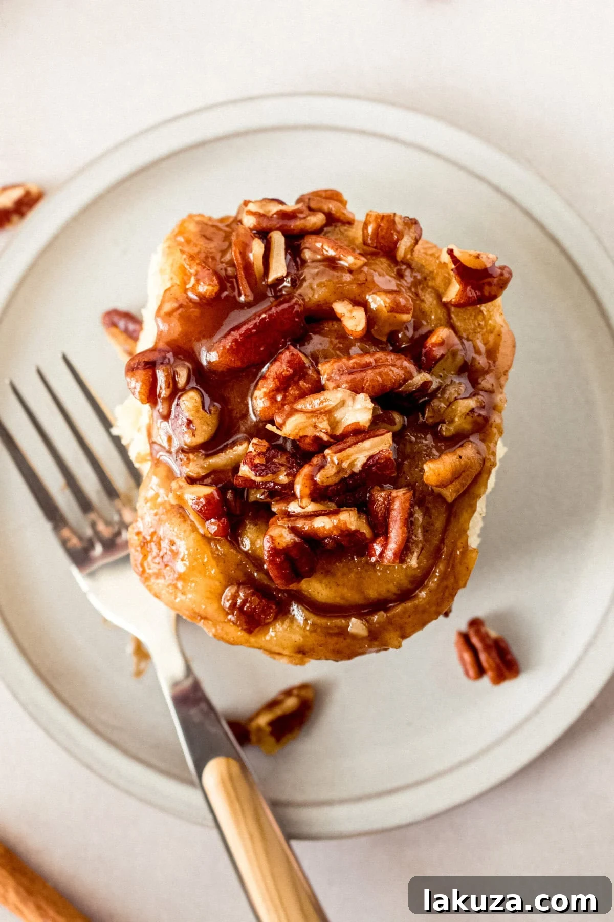 Caramel pecan sticky buns also known as caramel pecan rolls are homemade sweet rolls filled with a brown sugar cinnamon filling and topped with a rich caramel sauce and pecans. Sweet, nutty, and rich, this is the best sticky bun recipe!