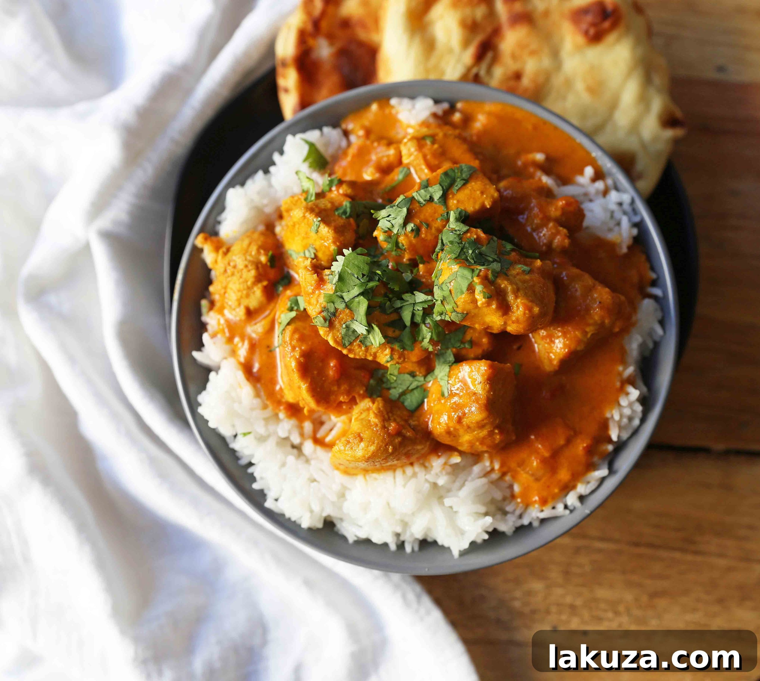 Rich and creamy Chicken Tikka Masala served with fresh cilantro, ready to be enjoyed with rice or naan.