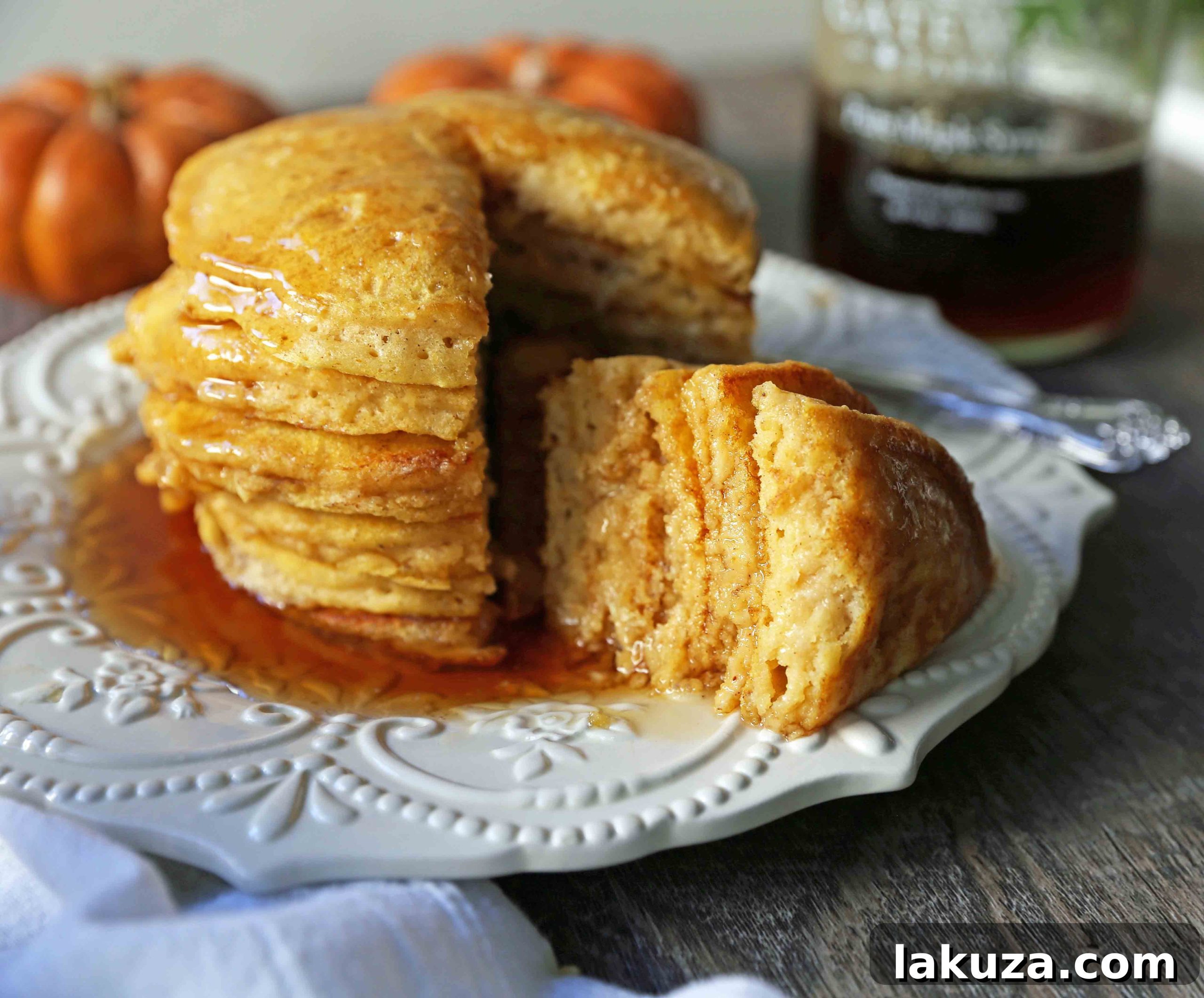 Cozy Pumpkin Spice Flapjacks 3 Enjoying a stack of fluffy pumpkin pancakes, generously drizzled with maple syrup. An ideal Fall breakfast recipe for any weekend.