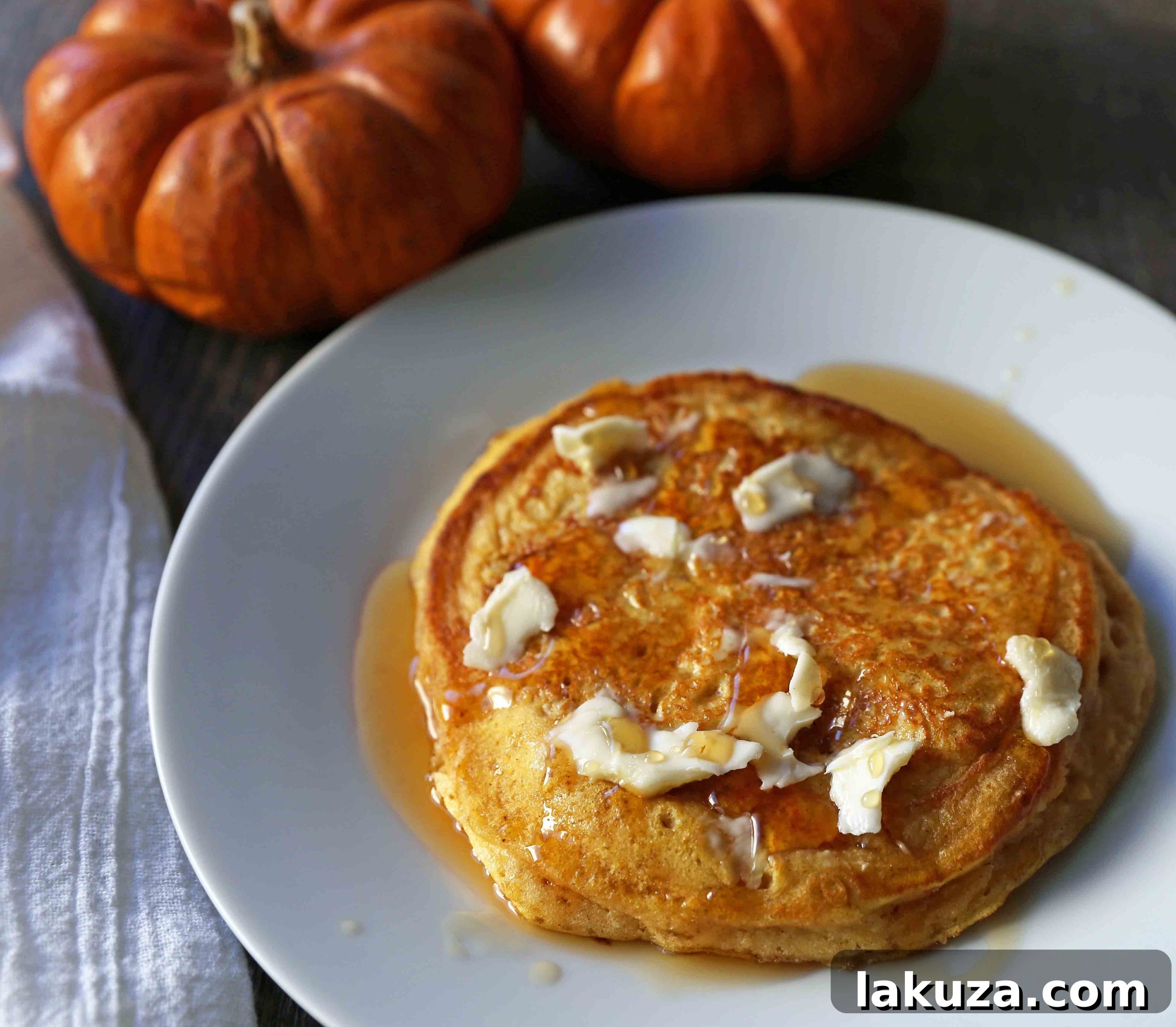 Cozy Pumpkin Spice Flapjacks 4 A close-up of a perfectly cooked pumpkin pancake, highlighting its fluffy texture and golden-brown edges. A must-try Fall breakfast.