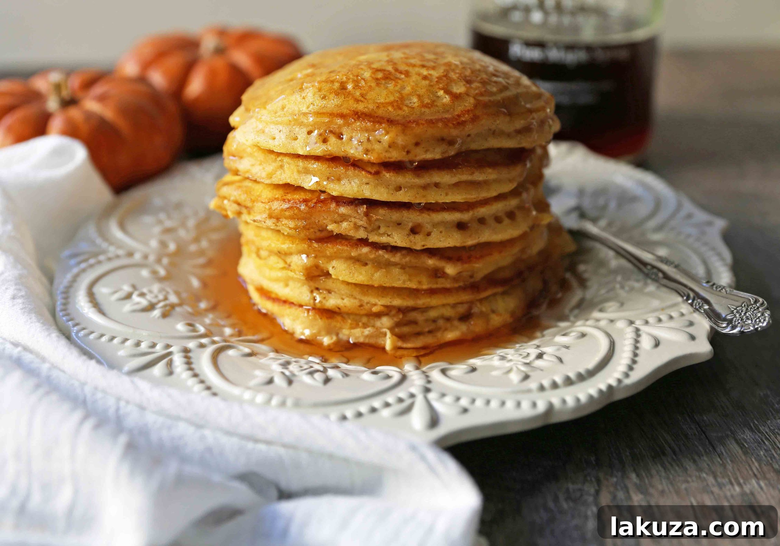 Cozy Pumpkin Spice Flapjacks 5 A stack of golden pumpkin pancakes, ready to be served with butter and maple syrup. The ultimate comfort food for Fall mornings.