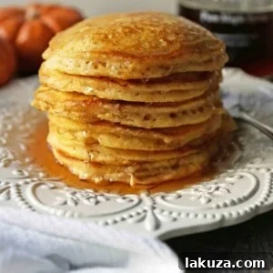 Cozy Pumpkin Spice Flapjacks 8 The BEST Pumpkin Pancakes. Light, fluffy, airy, and creamy pumpkin spiced pancakes. The perfect Fall breakfast. www.modernhoney.com #pumpkin #pumpkinpancakes #pumpkinrecipes #pumpkinbreakfast #fallbreakfast #pumpkinspice