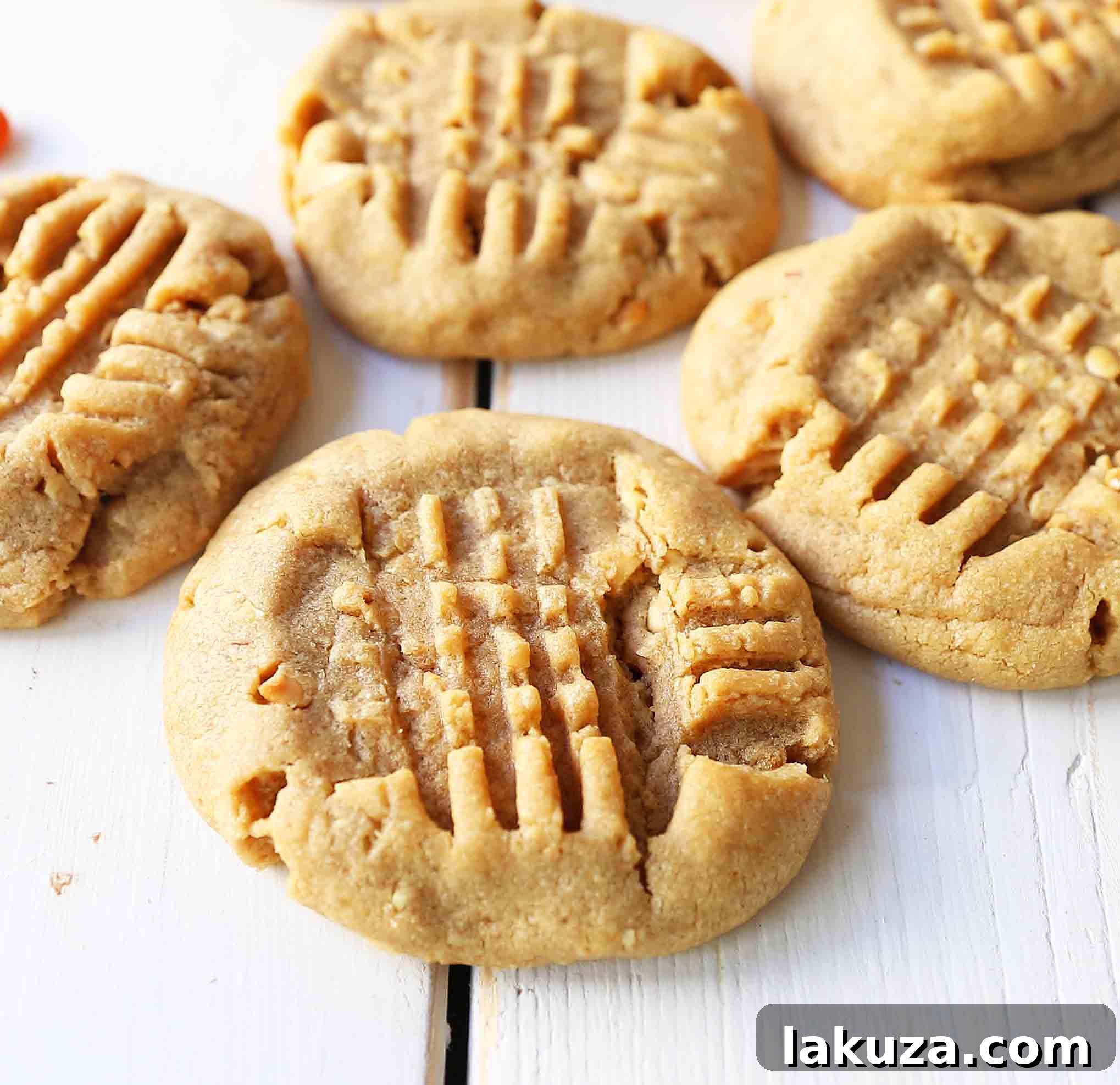Irresistibly Soft and Chewy Peanut Butter Cookies with Crisp Edges and Crunchy Peanuts. The ultimate homemade cookie recipe for a perfect treat.